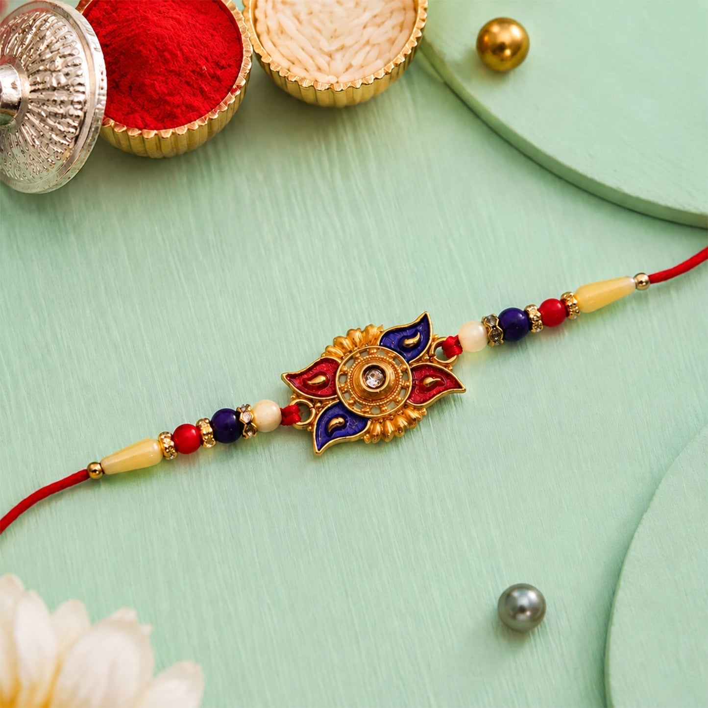 Close-up of red blue floral kundan rakhi decorative beads