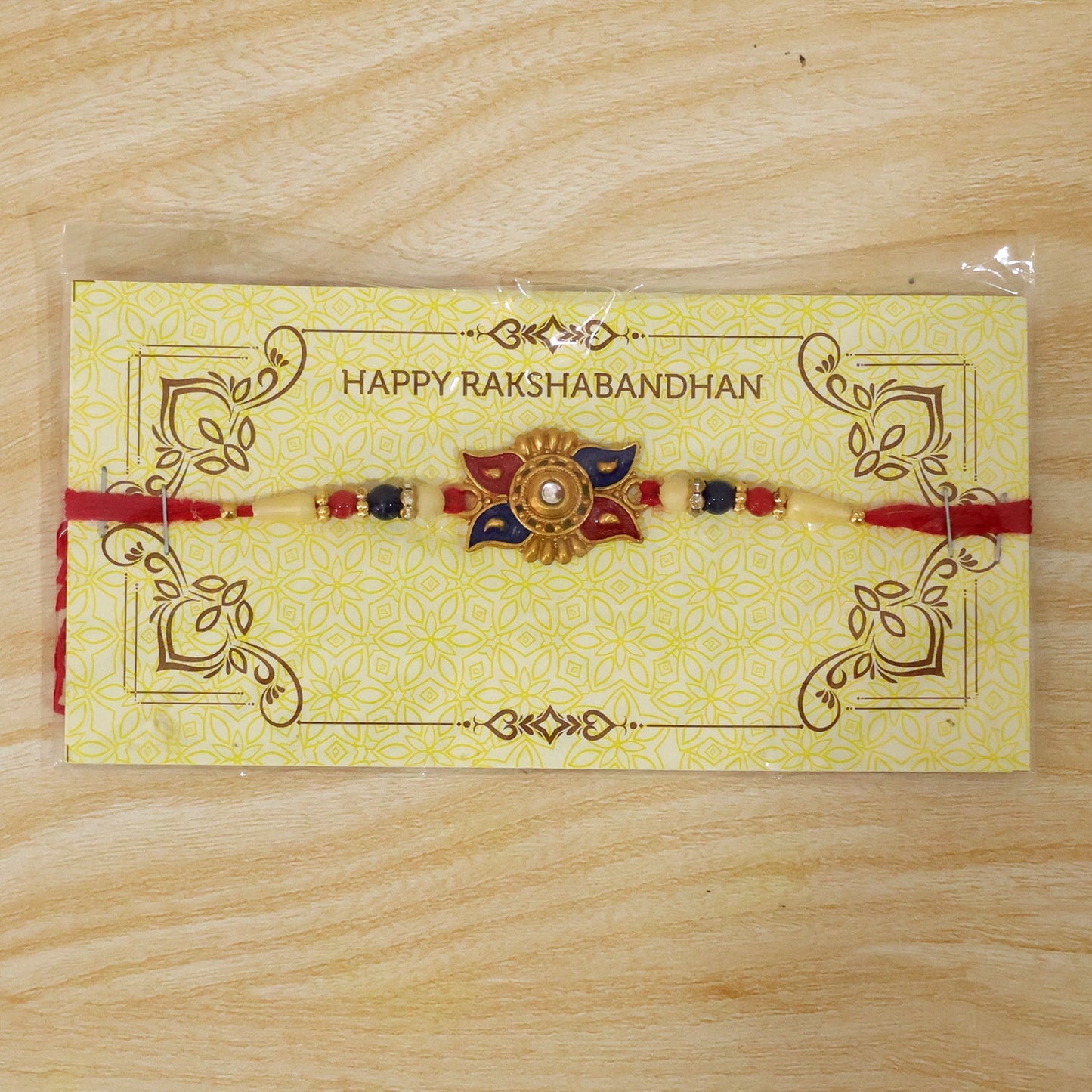 Pearl bead centerpiece in red blue floral kundan rakhi