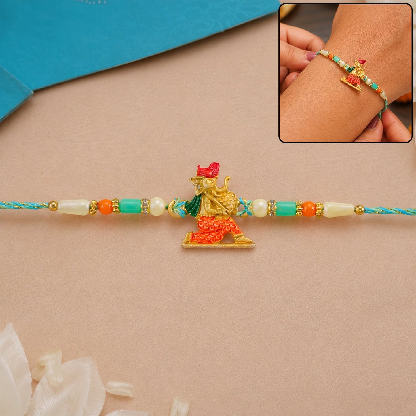 Ganesh Charm Rakhi featuring turquoise and pearl beads with detailed beadwork