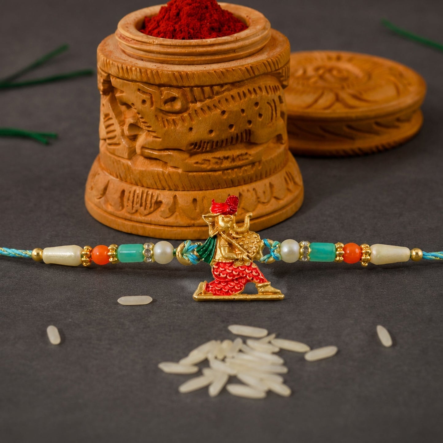 Ganesh Charm Rakhi with thread and pearl detailing