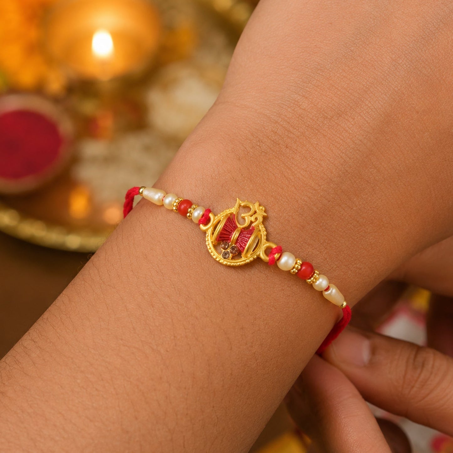 Raksha Bandhan rakhi on wrist showing red thread style.