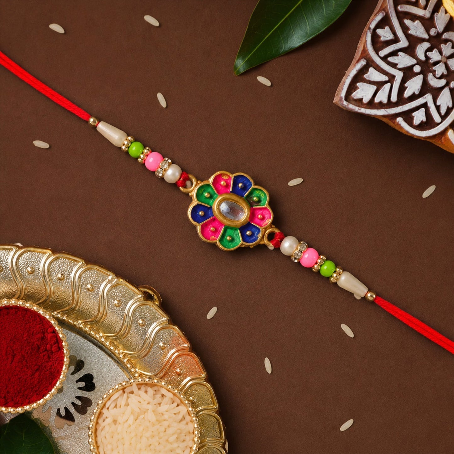 Detailed design of multicolor rakhi with pearl beads