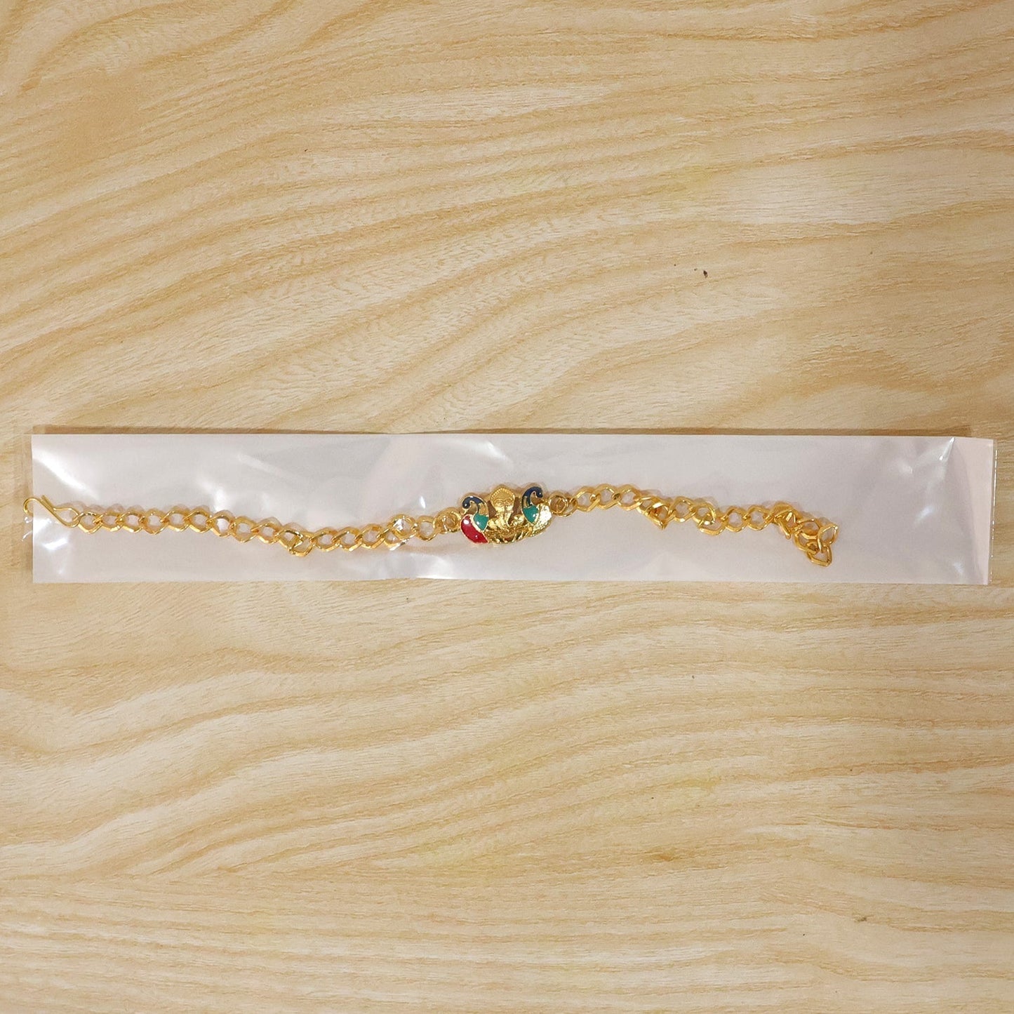 Festive Peacock Ganesh rakhi with thread and beads