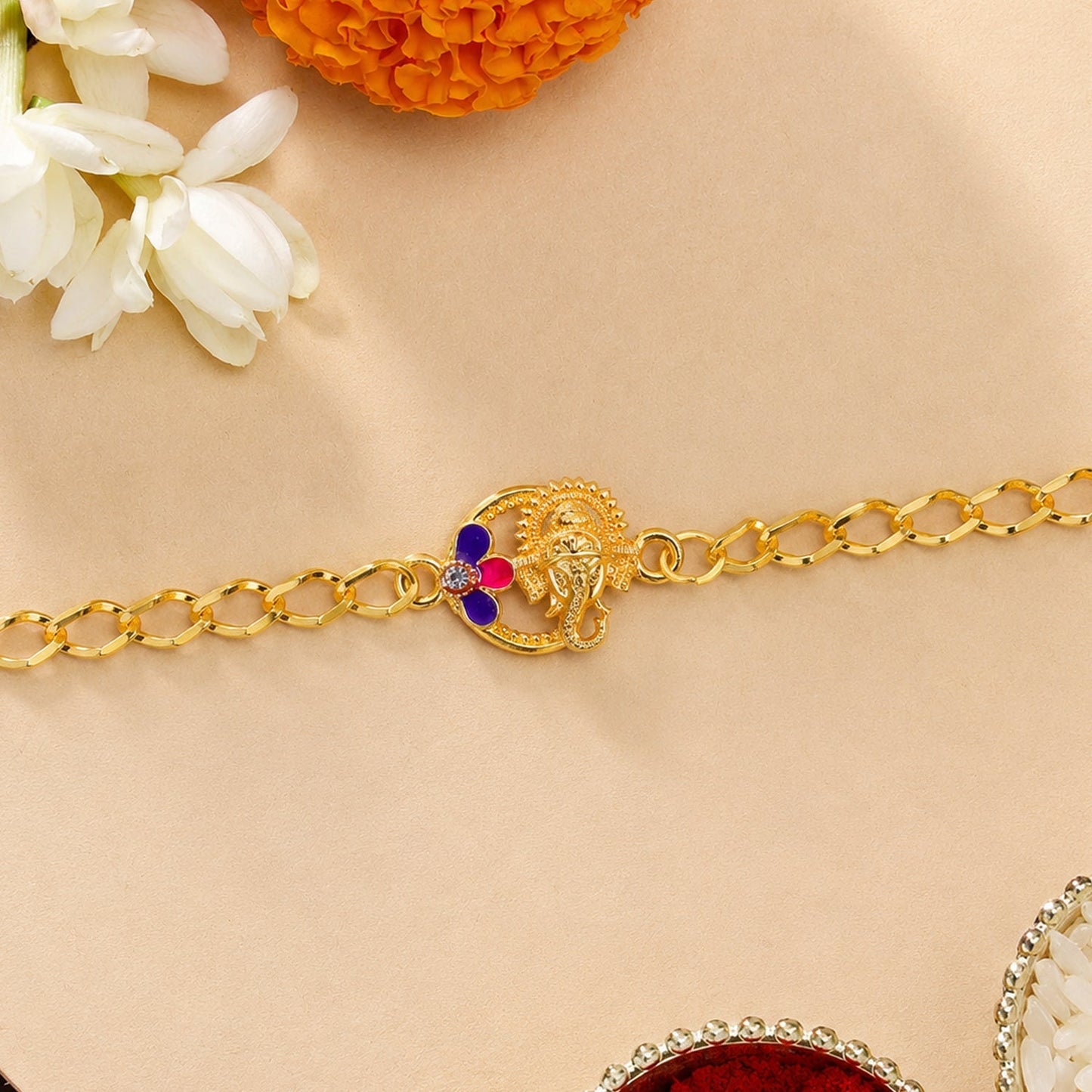 Close-up of decorative beads and thread of the spiritual Lord Ganesha Rakhi.