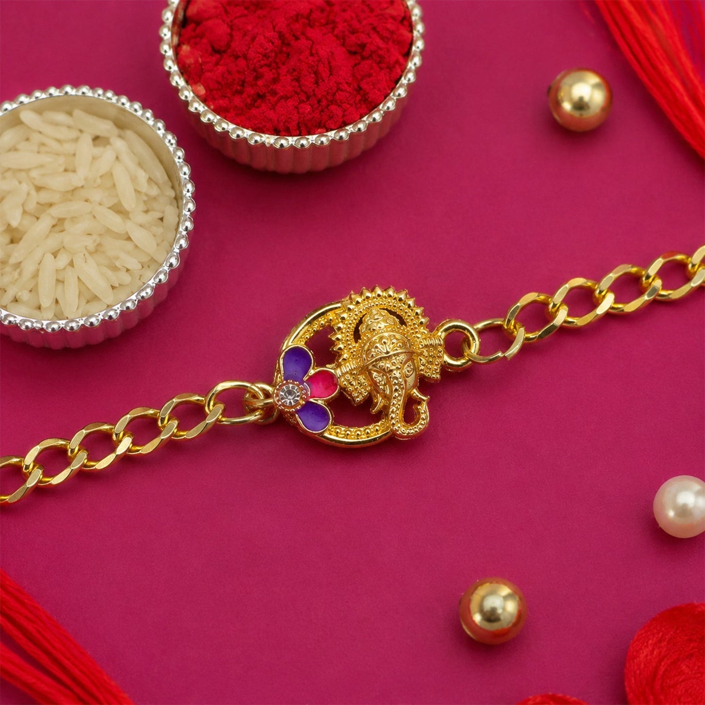 Lord Ganesha Rakhi bracelet featuring a prominent Ganesha idol and intricate design.