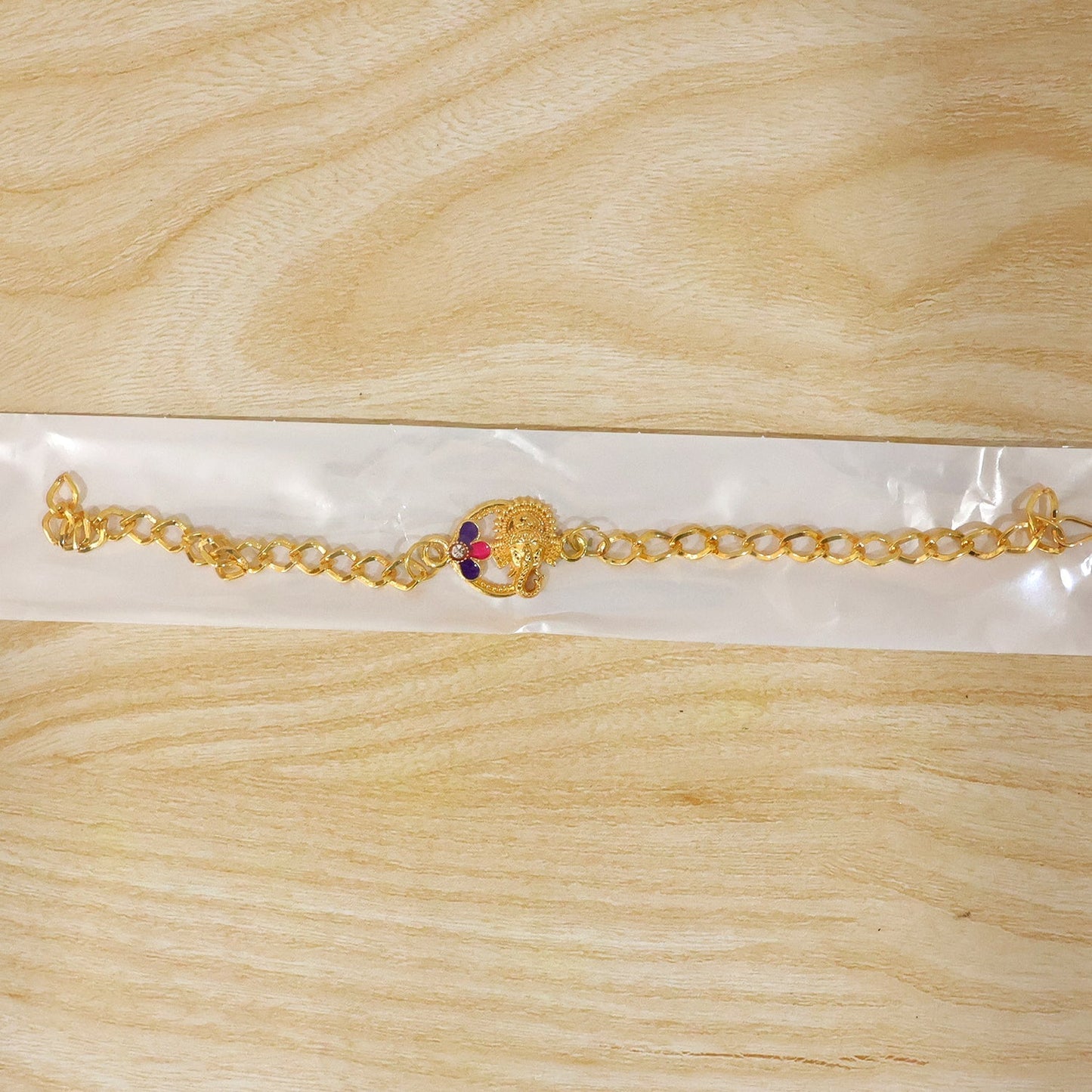 Lord Ganesha Rakhi bracelet styled beautifully on a wrist for Raksha Bandhan.