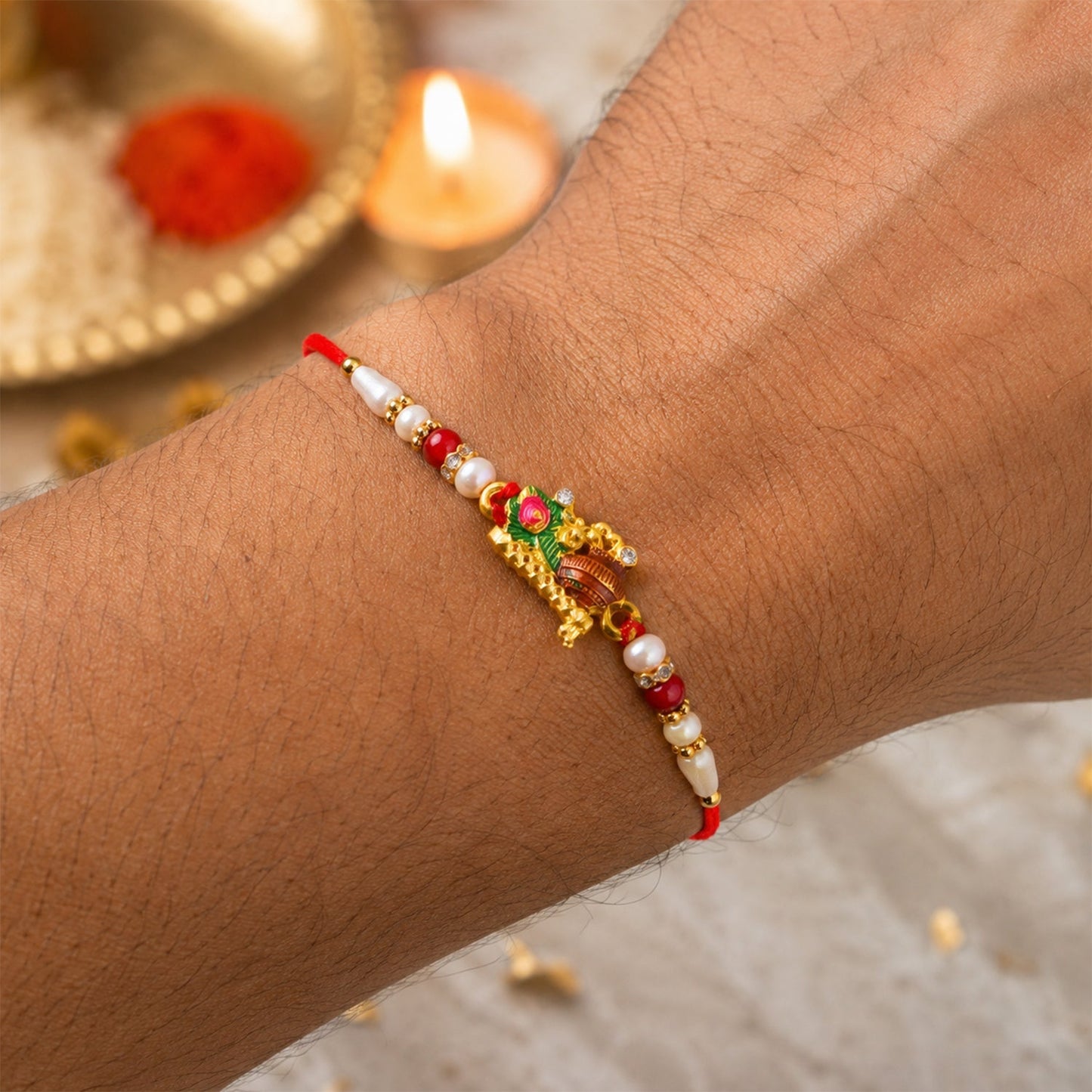 Elegant Rakhi with peacock feather design and gold-tone finish for Raksha Bandhan