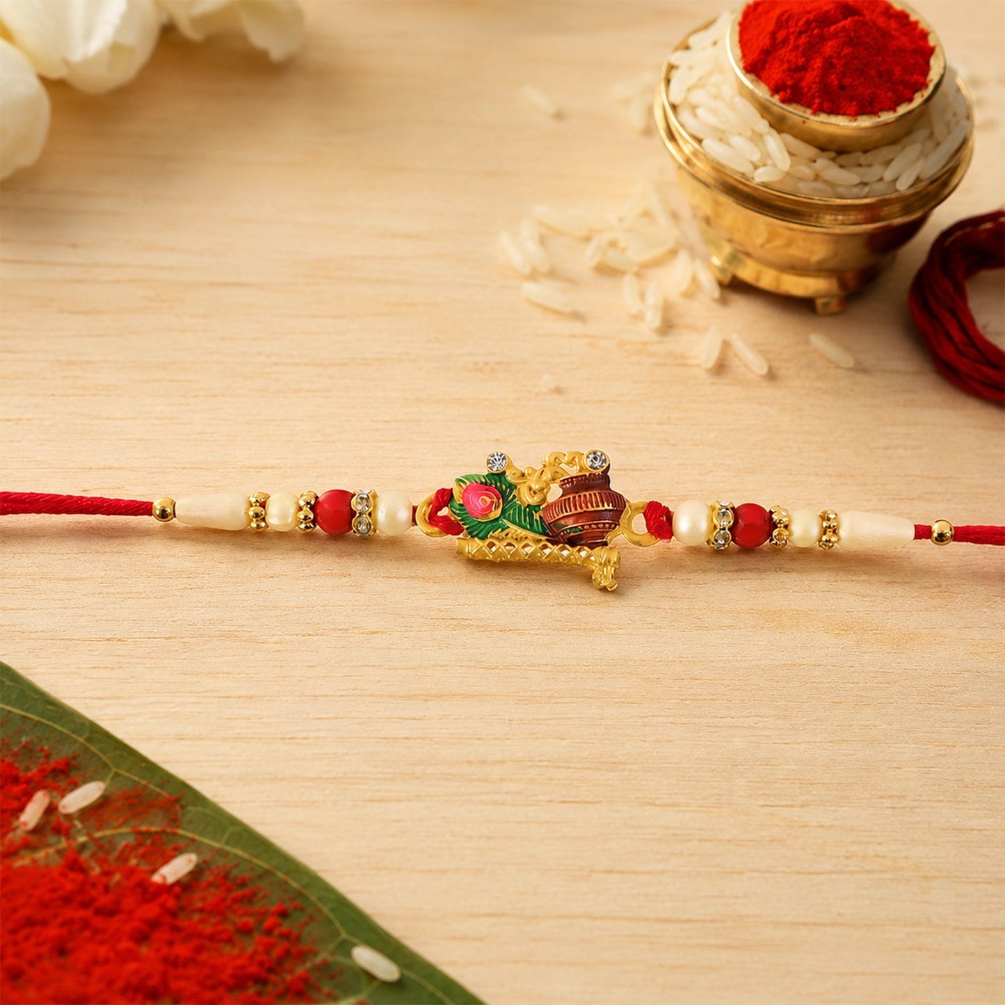 Traditional Rakhi with pearl beads and peacock motif for sibling celebration