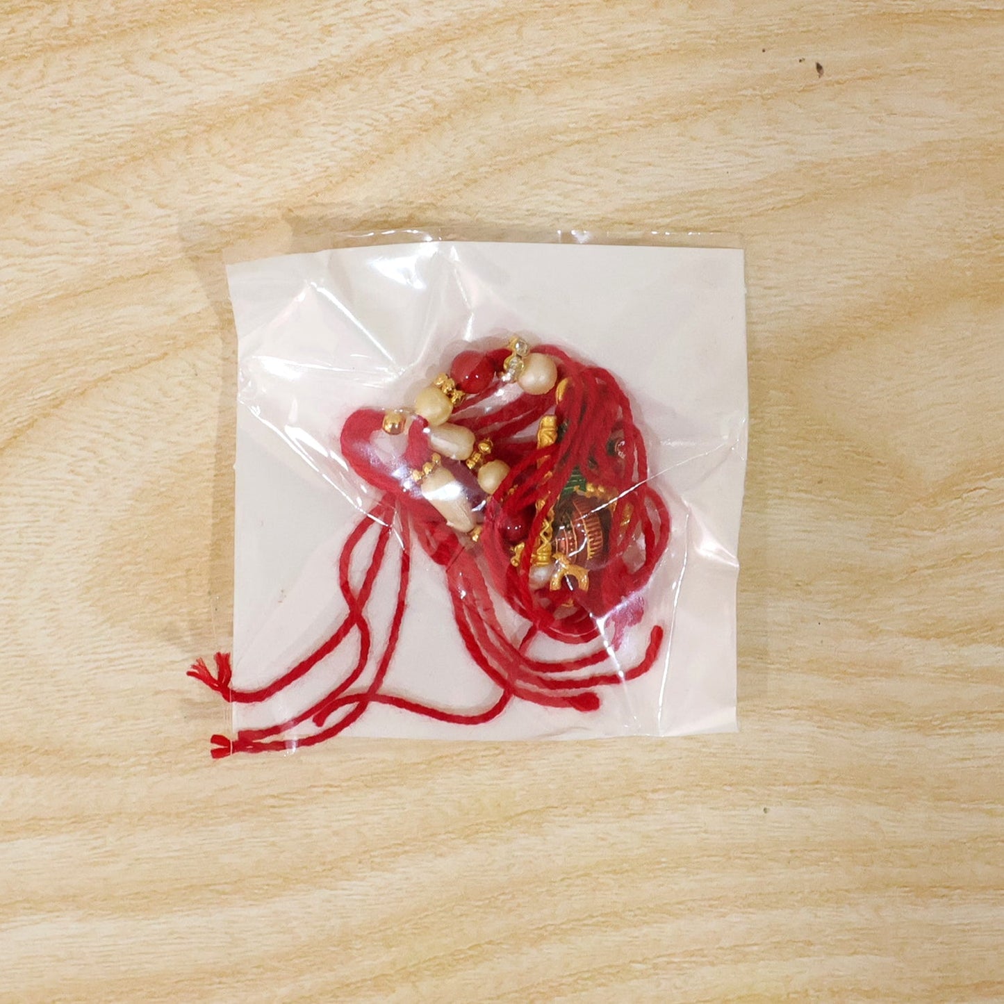 Stylish Rakhi with peacock feather and gold-tone accents for Raksha Bandhan