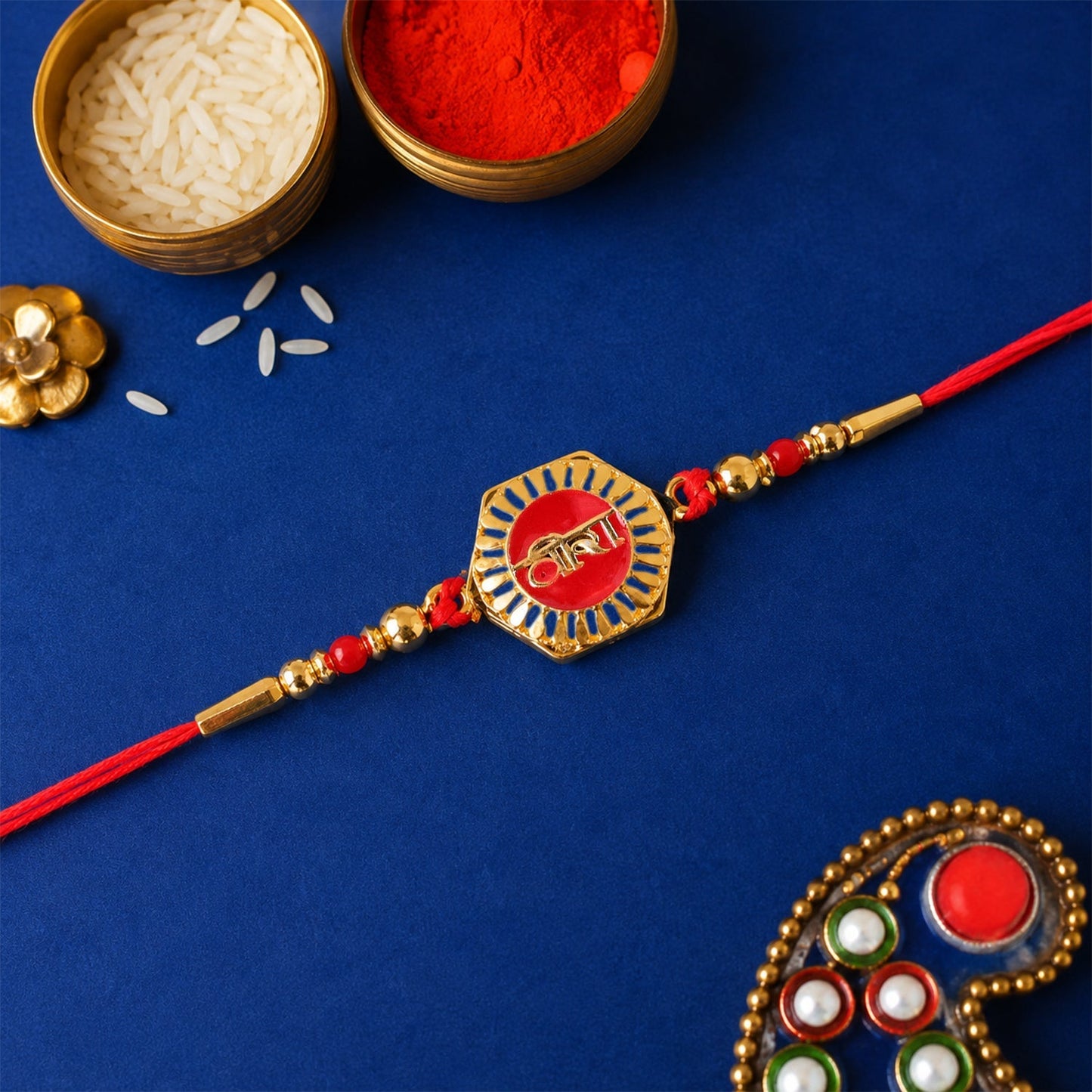 Side view of Veera Red Enamel Gold Tone Rakhi emphasizing details