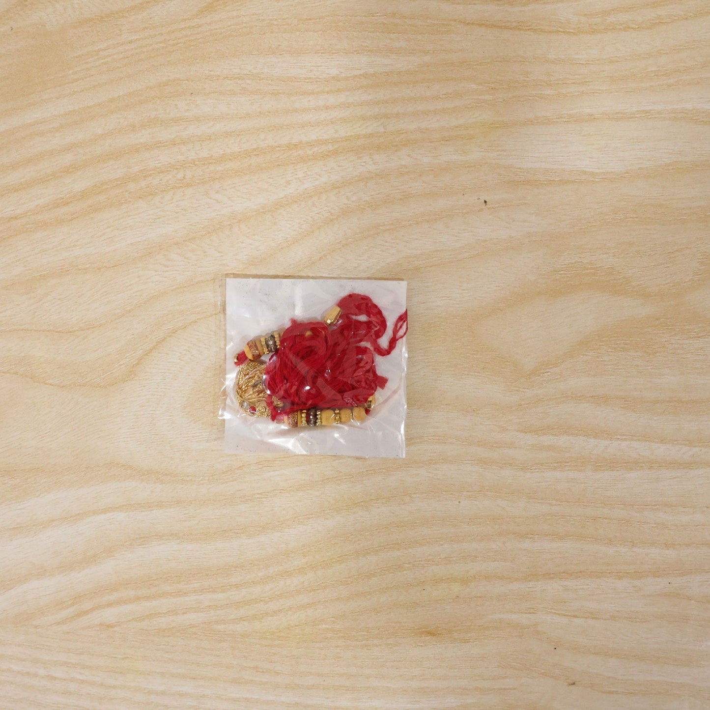Elegant Golden Tone Rakhi displayed for festival gifting