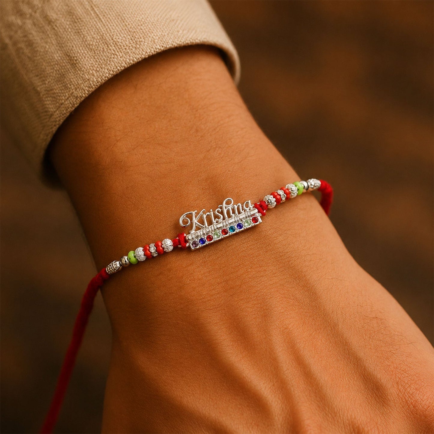 Stylish Krishna Rakhi featuring divine motifs and sparkling stones