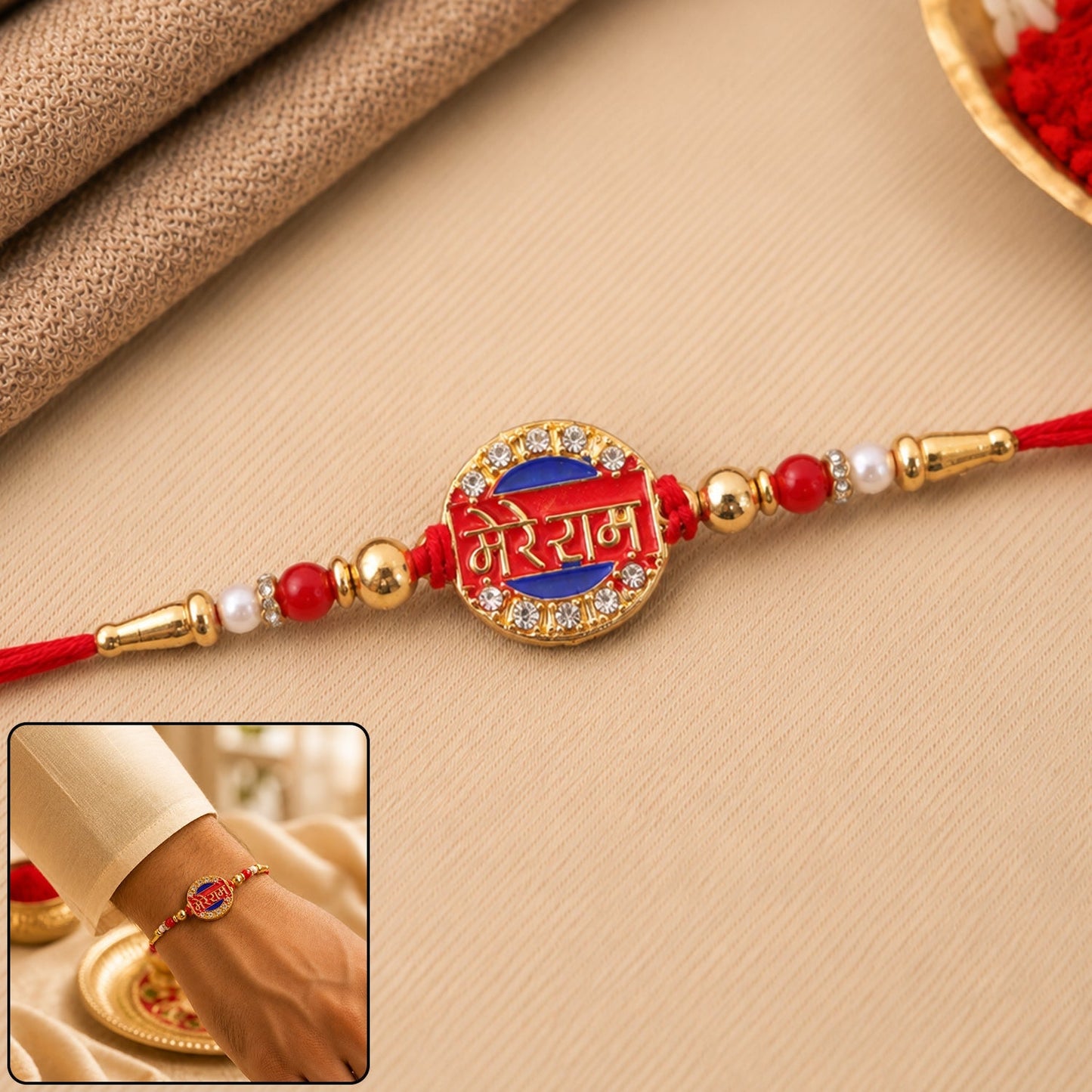 Close-up of gold tone Rakhi with stones and 'Mere Ram' text
