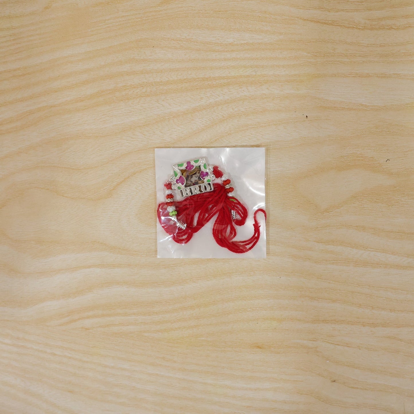 Back view of 'Bro' Rakhi showing thread knot and frame