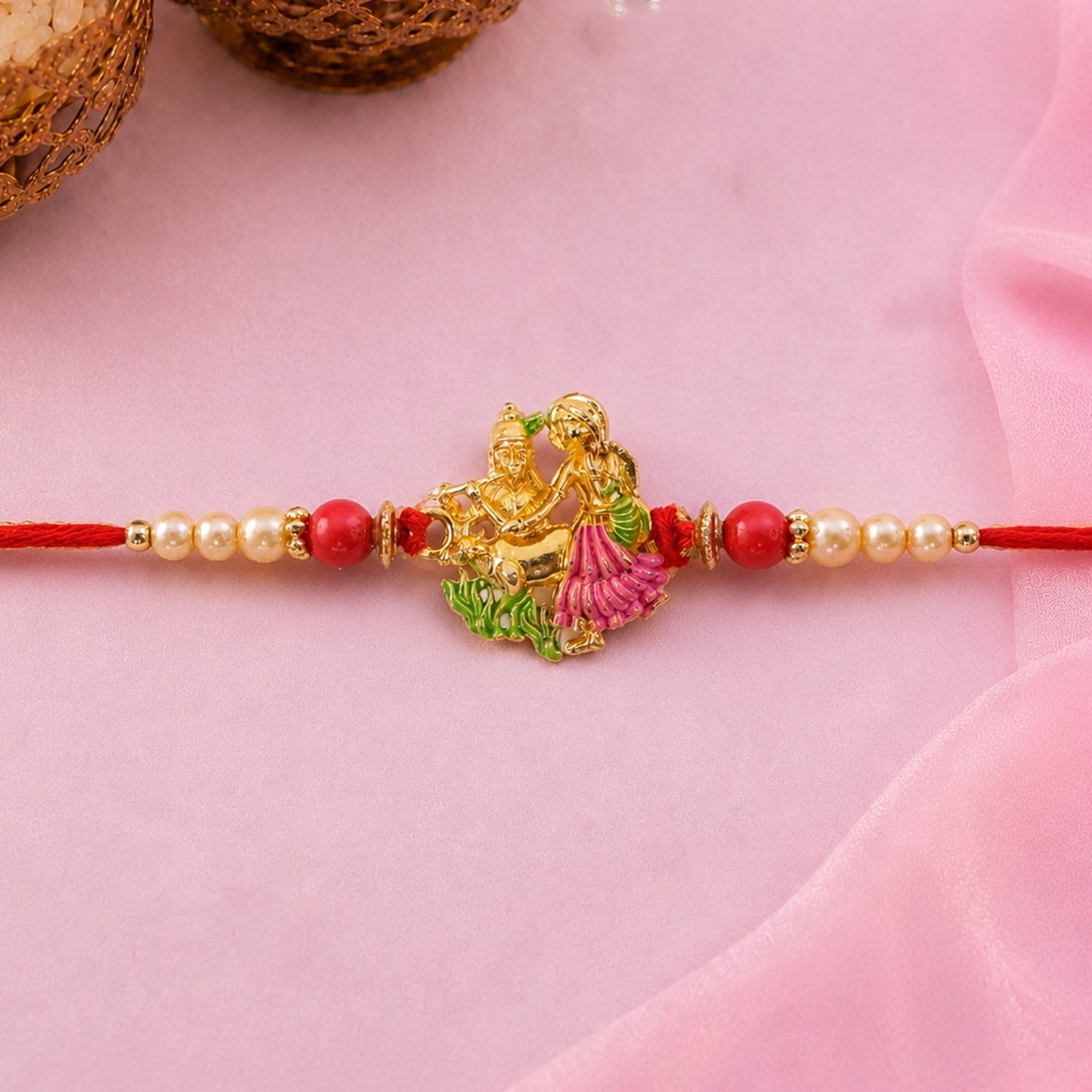 Close-up of Radha Krishna detailed enamel motif on rakhi