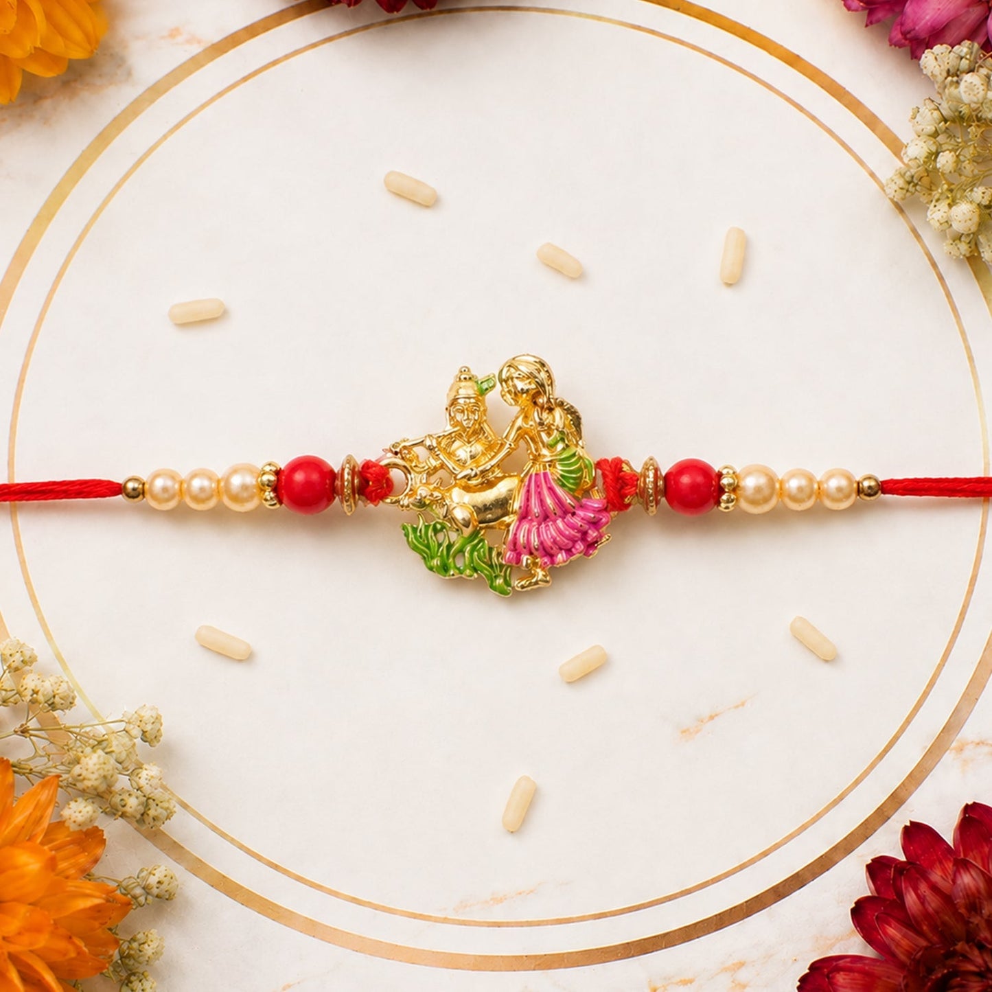 Elegant Radha Krishna enamel rakhi with pink & green accents