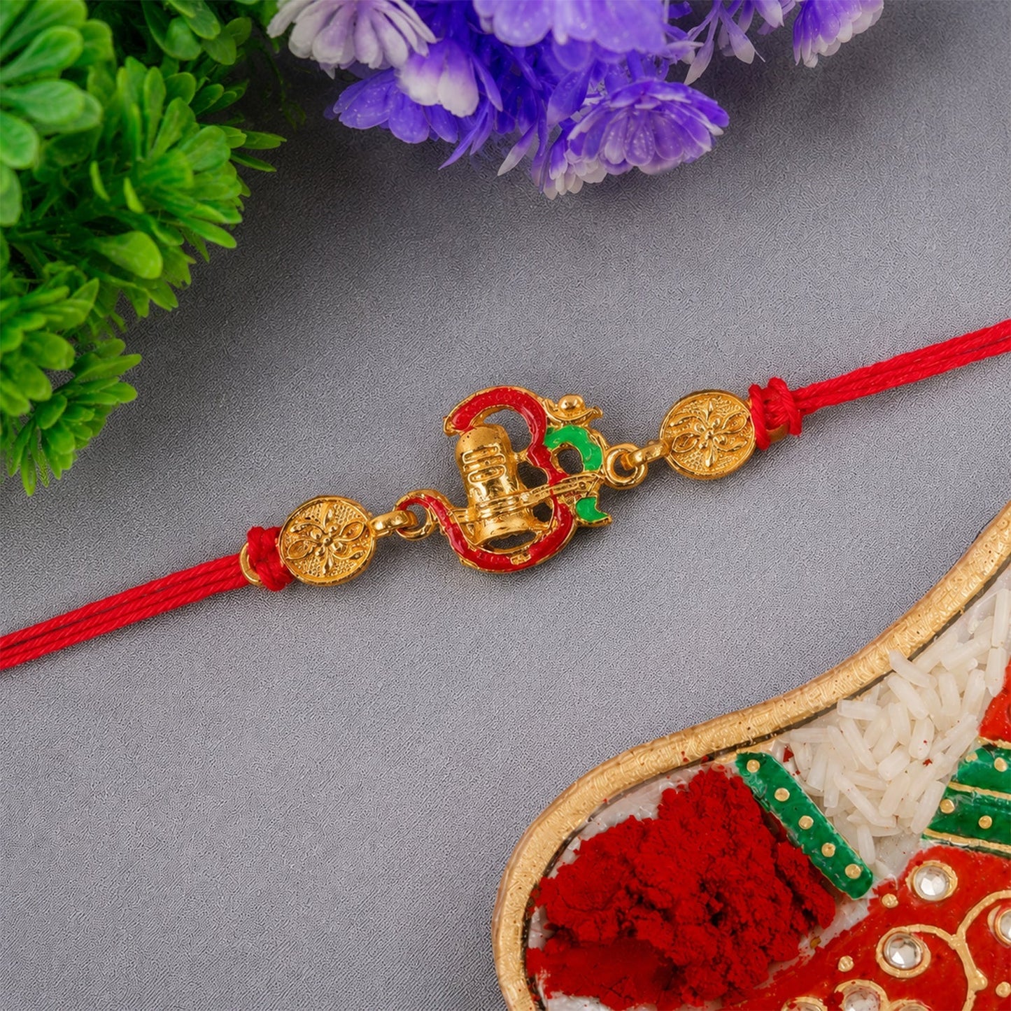 Elegant gold tone Shivling Rakhi with detailed craftsmanship