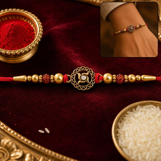 Golden Swastik Rakhi with red crystal beads, front view