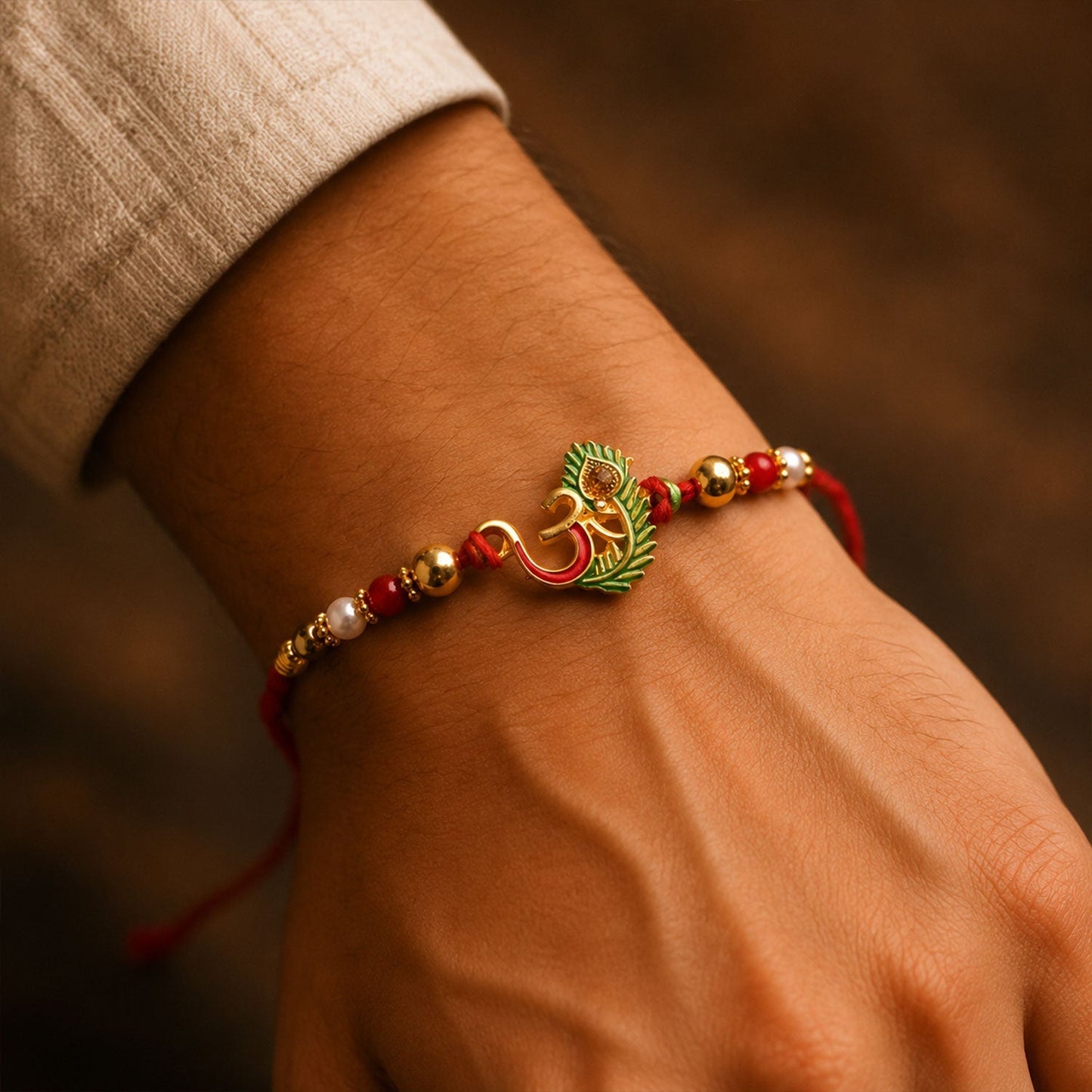 Close-up of Om Peacock Feather Green Enamel Rakhi showcasing detailed craftsmanship