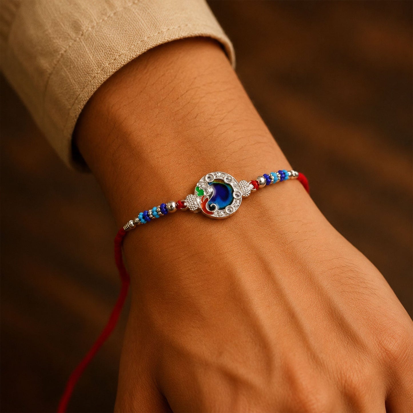 Beautiful decorated Rakhi featuring peacock design with blue stone for brother's blessings.