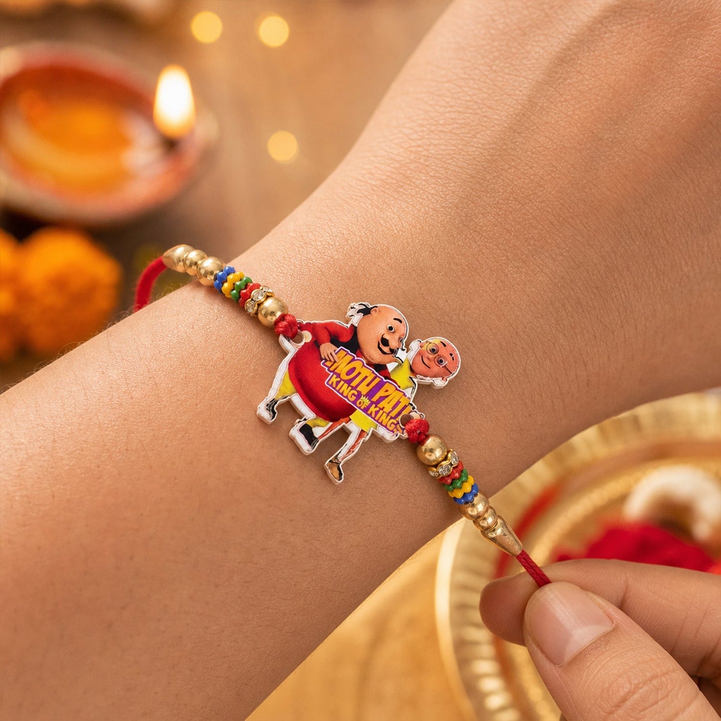 Colorful cartoon rakhi with playful beads suitable for brothers of all ages