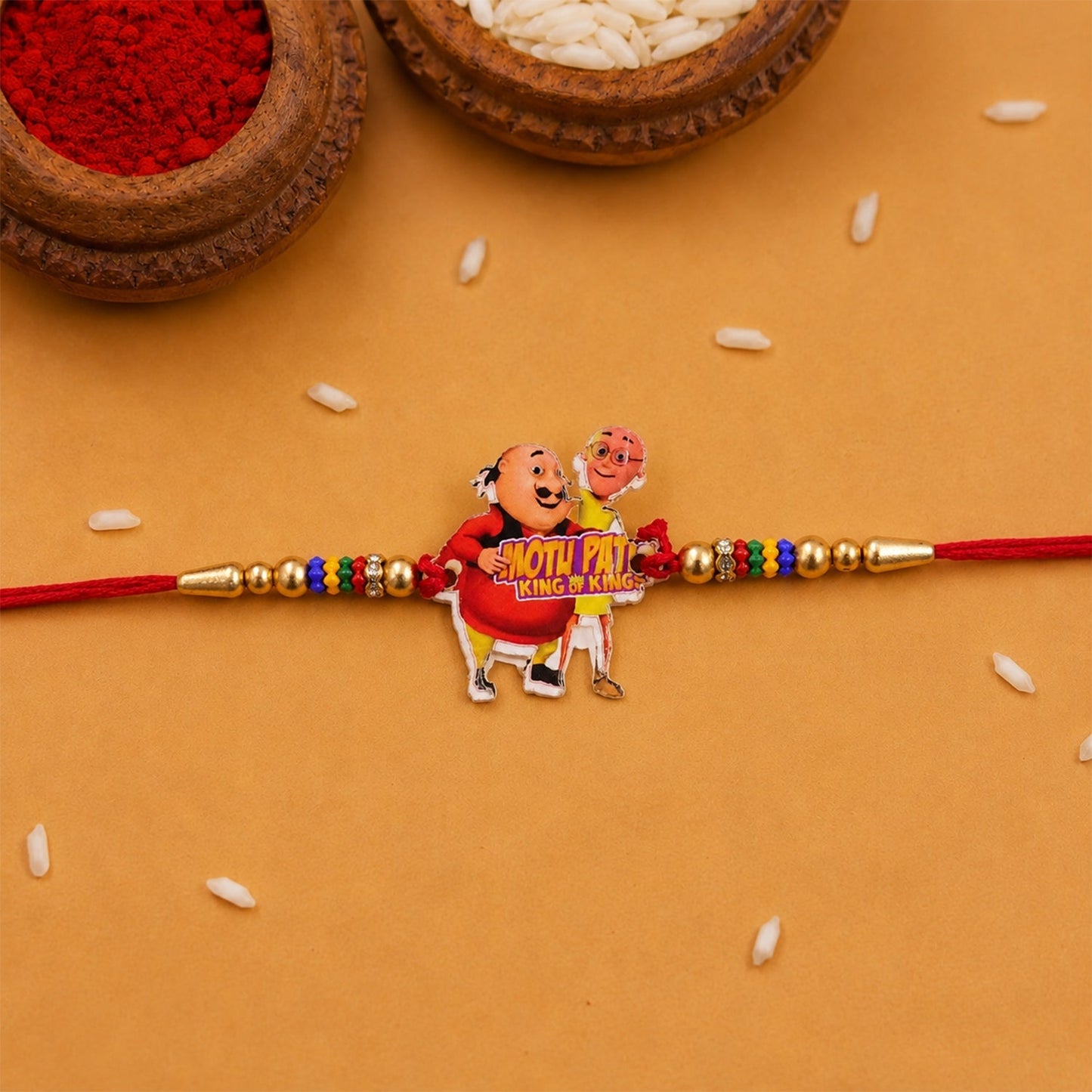 Festive multicolor beaded rakhi with cartoon motif for Rakshabandhan
