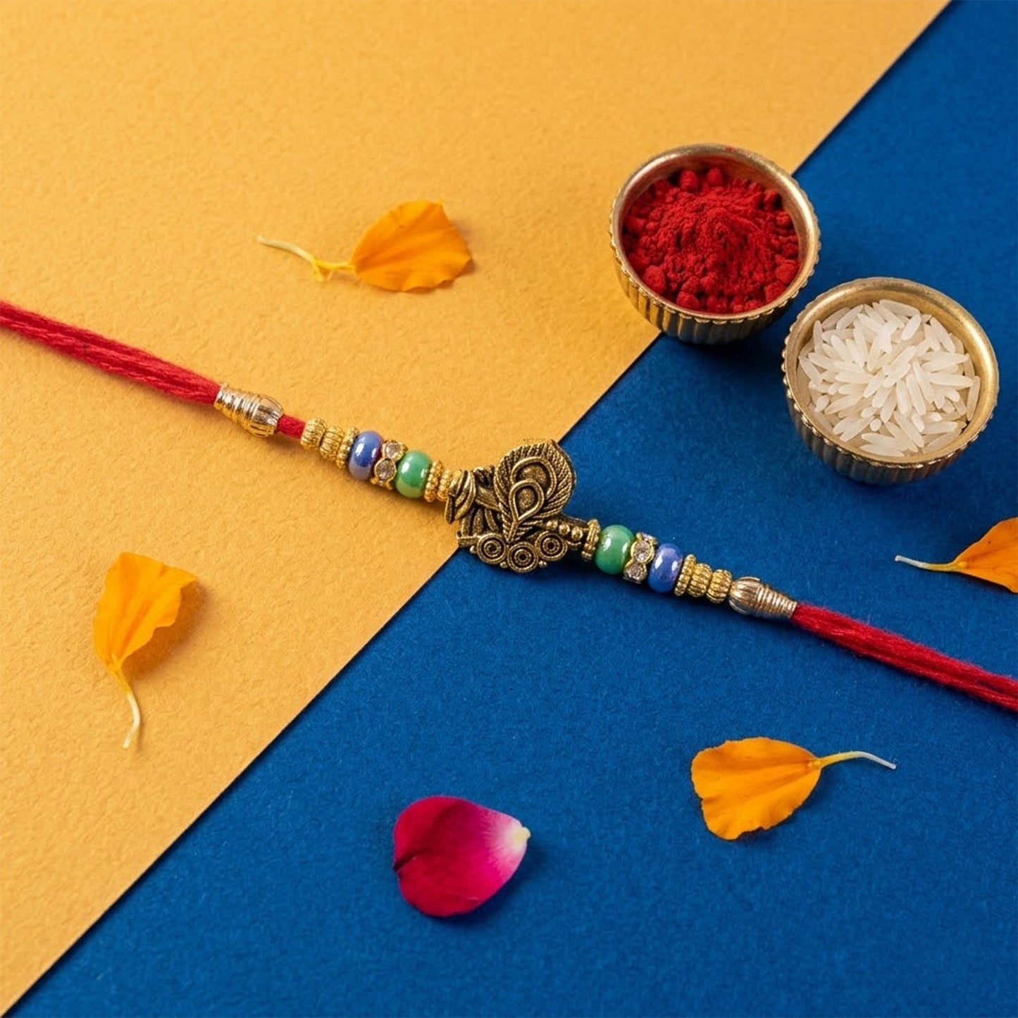 Rakhi featuring antique peacock motif worn on a brother's wrist