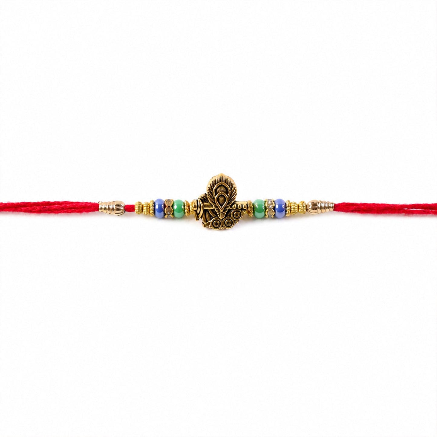 Top view of golden peacock motif on traditional rakhi