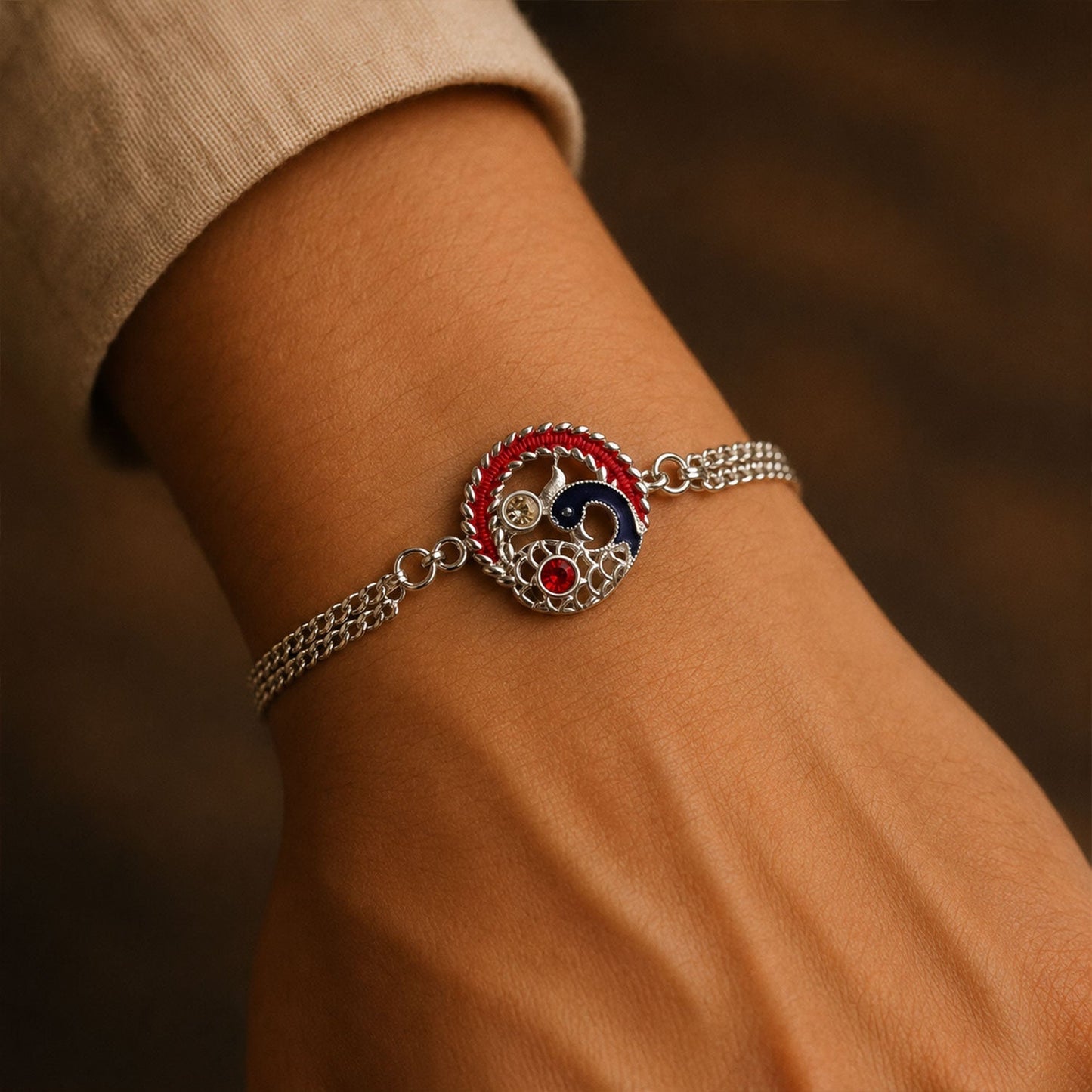 Designer Peacock Rakhi displayed on a white background, showcasing its festive design