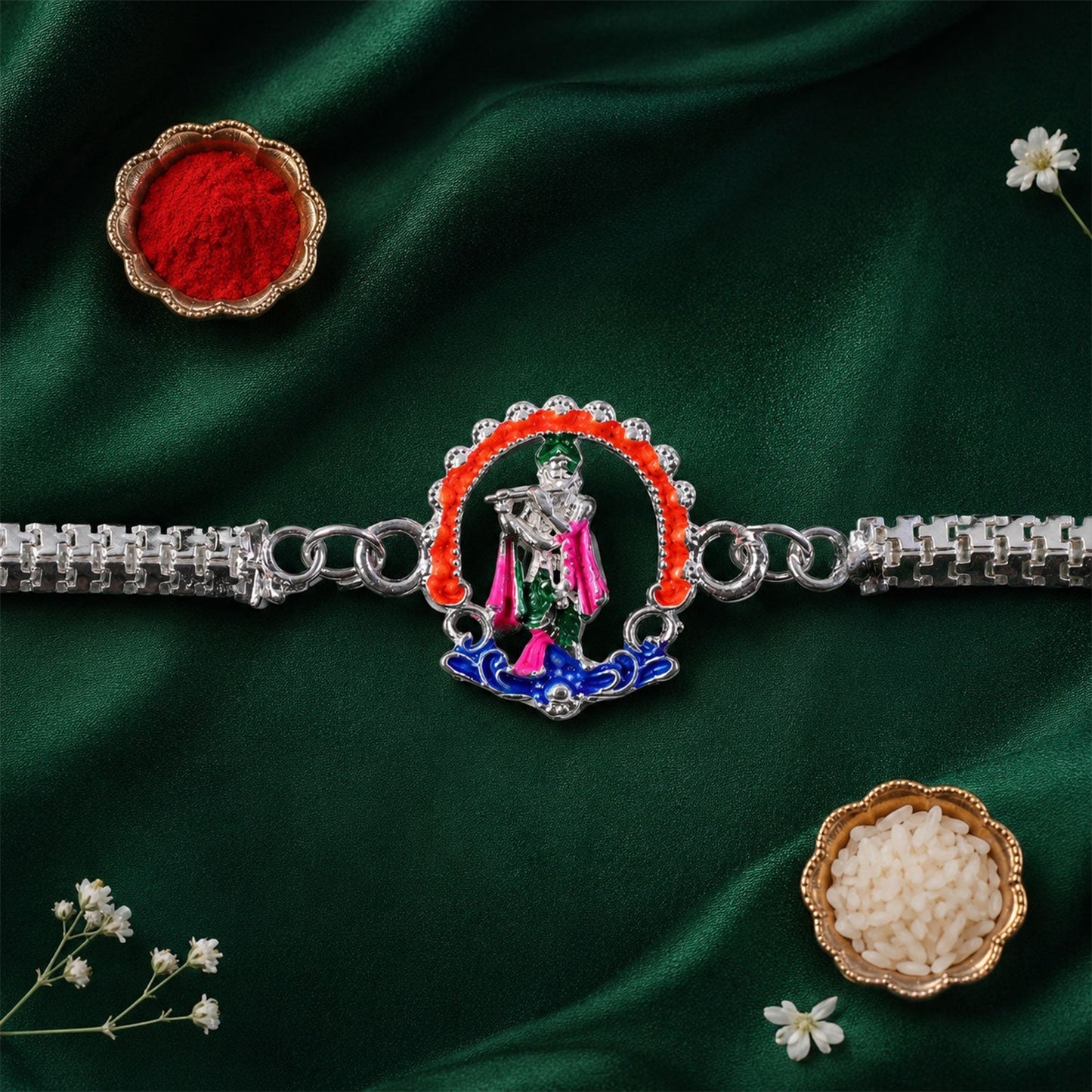 Silver Krishna Rakhi on a festive decorative surface