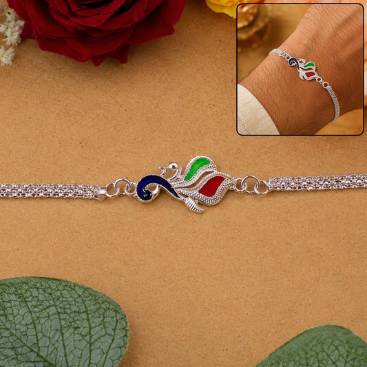 Close-up of Silver Peacock enamel design on festive Rakhi for brothers