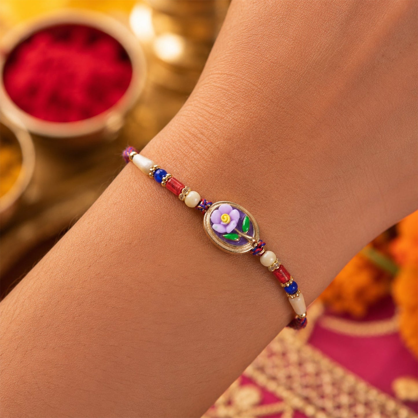 Elegant floral and Kundan Bhaiya Bhabhi Lumba Rakhi on a white background