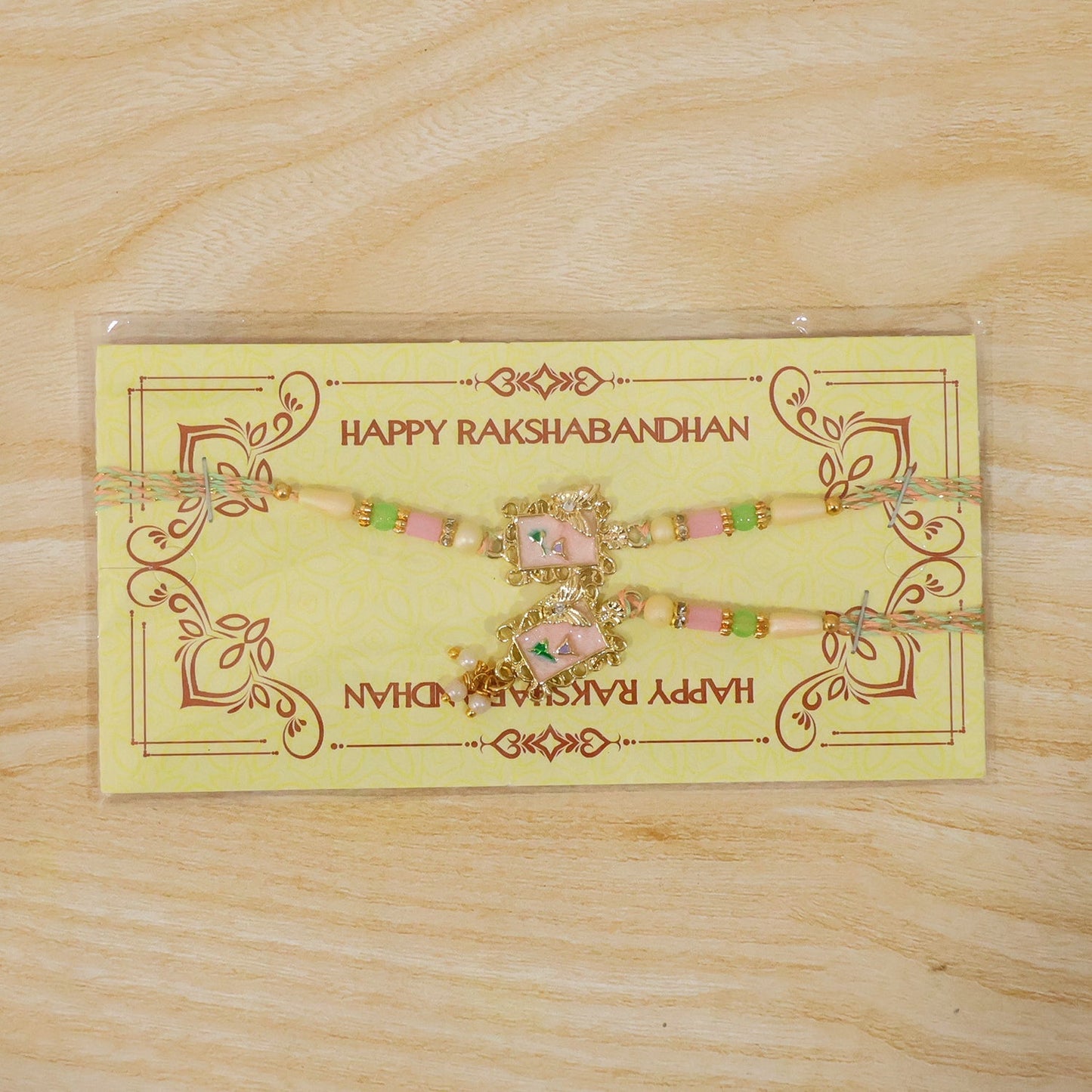 Festive pink floral rakhi with pearls, perfect for brother and sister.