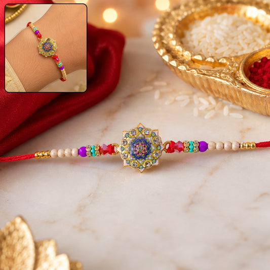 Front view of the floral mandala Rakhi with multicolor enamel and stone details.