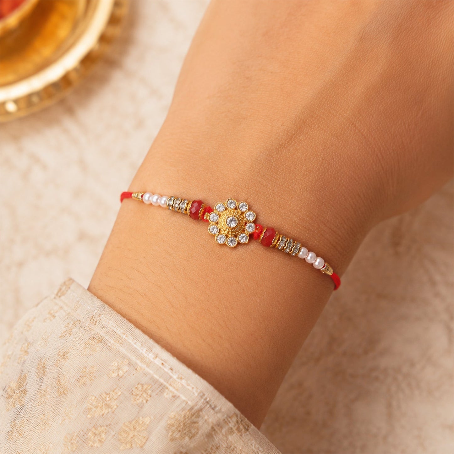 Beautiful diamond flower motif on a premium rakhi for Raksha Bandhan
