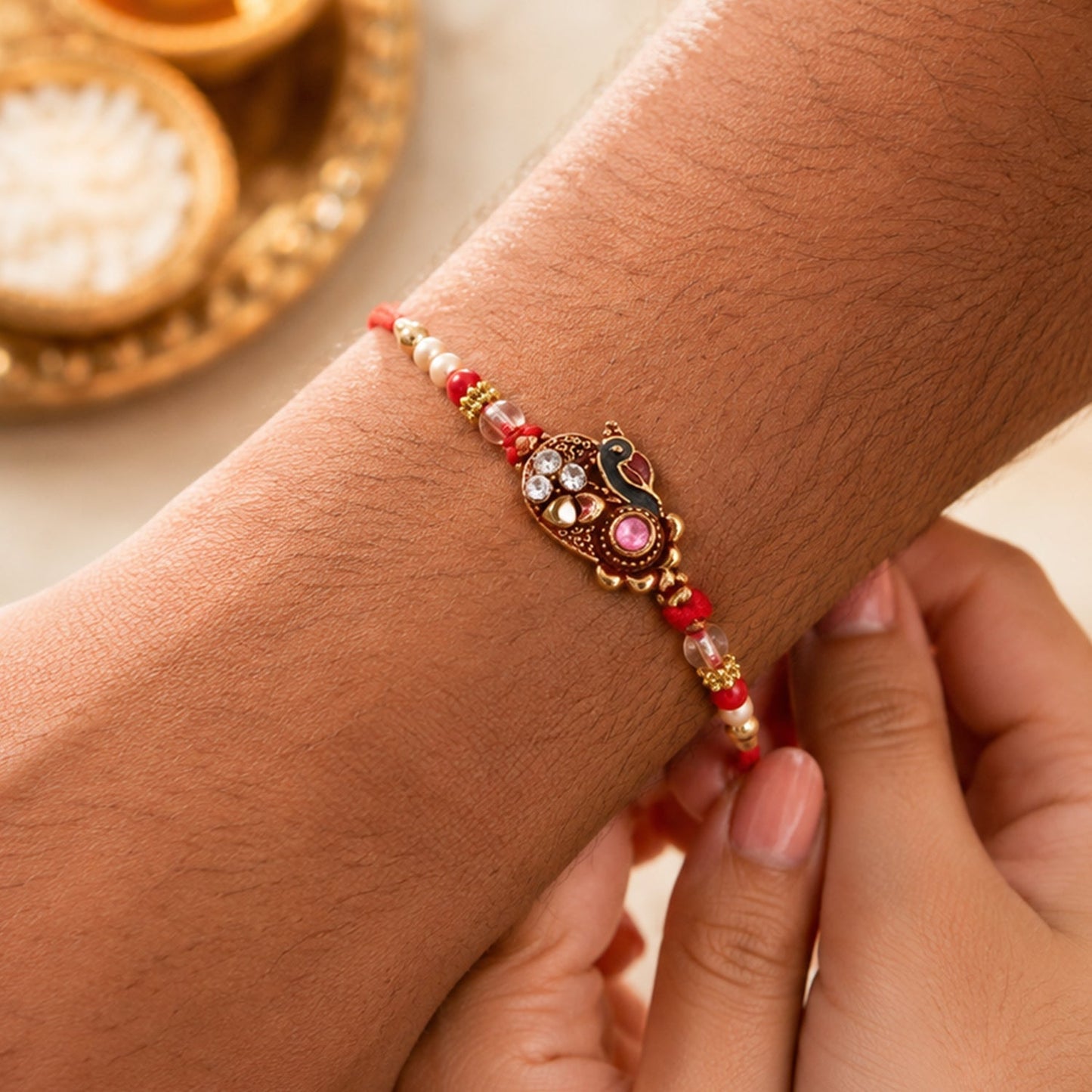 Side view of traditional Lumba Rakhi highlighting intricate stone-studded details.