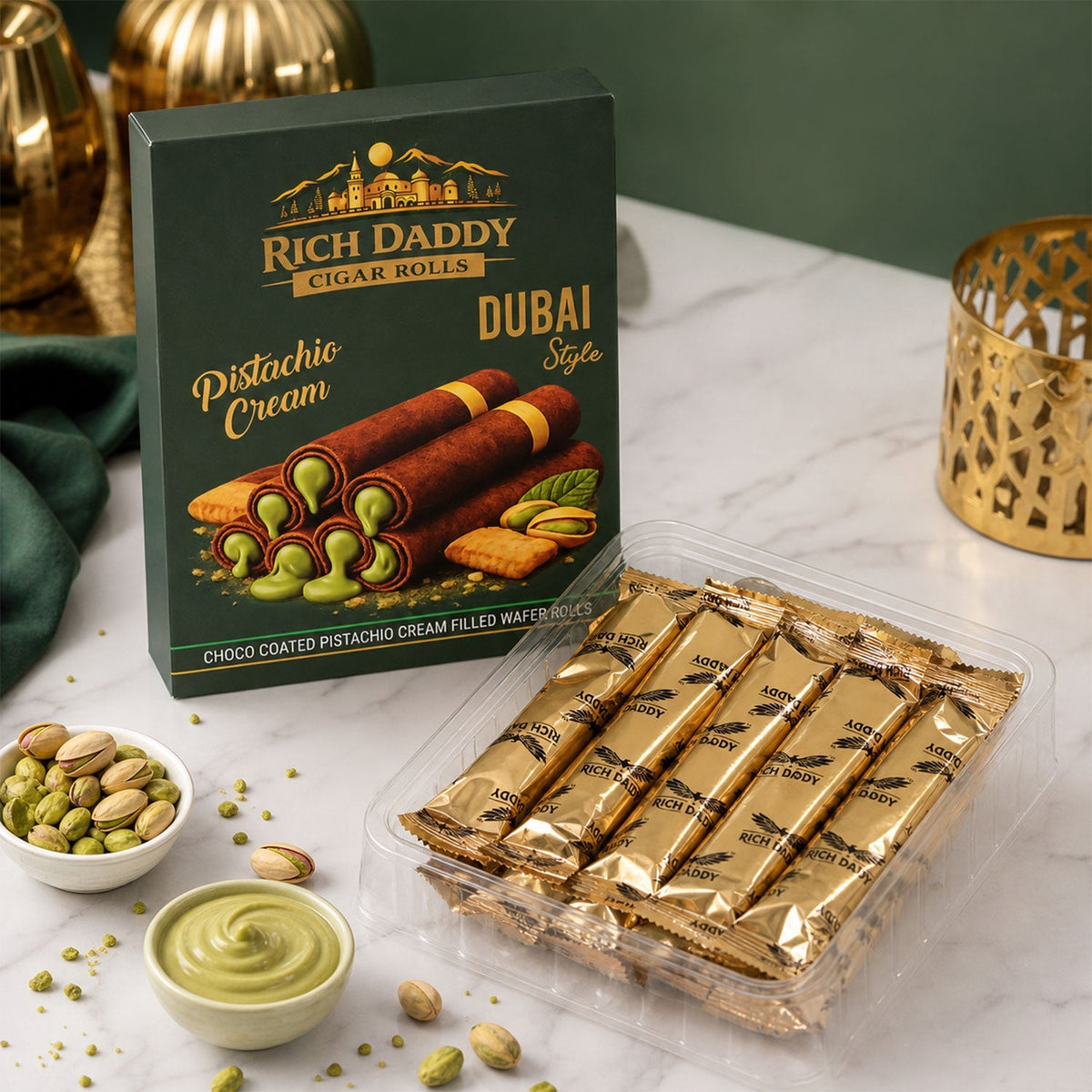 Green box of Rich Daddy Cigar Rolls next to a clear plastic tray of individually wrapped gold foil wafer rolls.