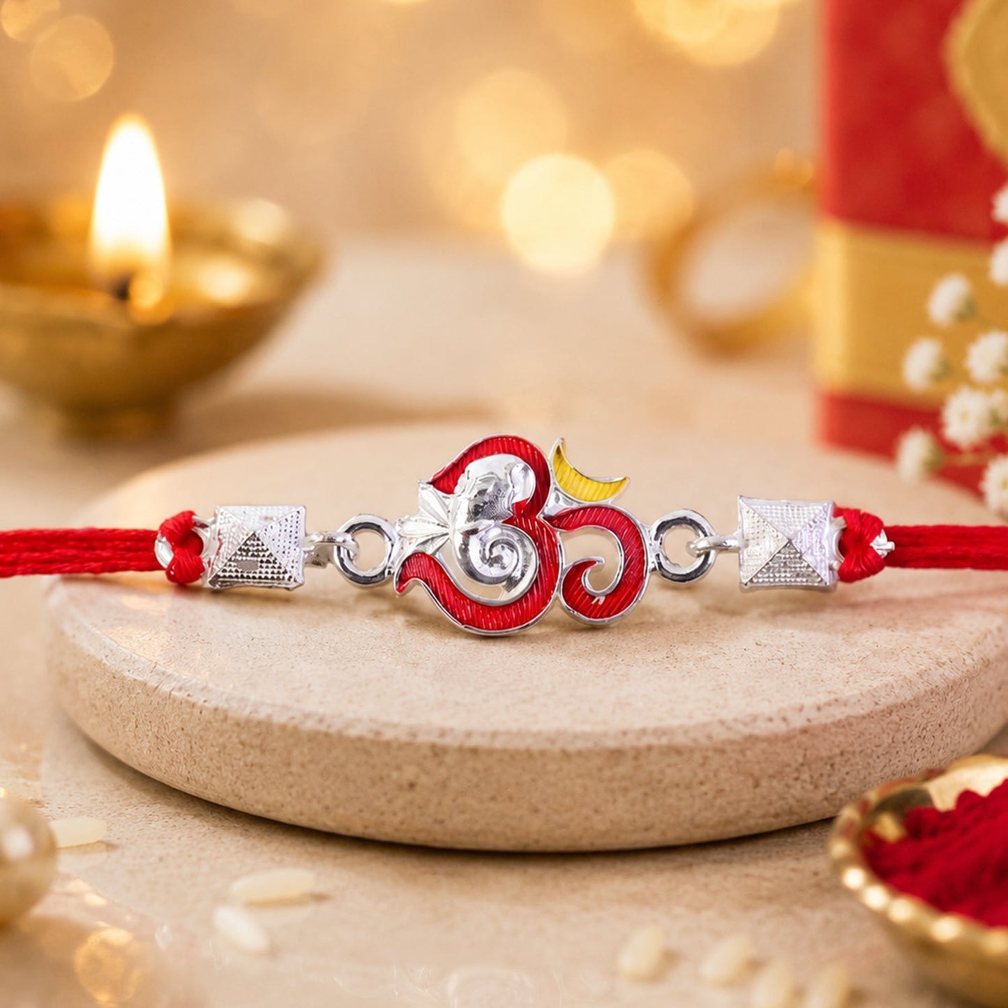 Elegant silver Om Ganesha enamel pyramid bead rakhi for Raksha Bandhan