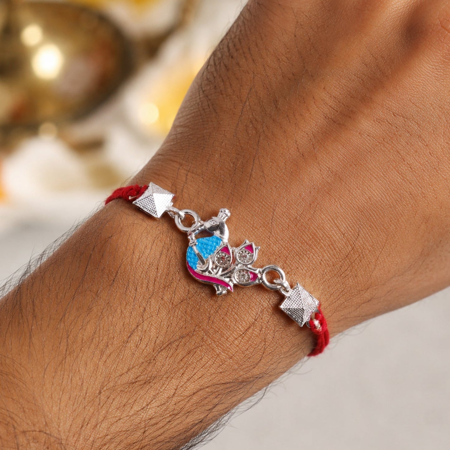 Elegant silver peacock Rakhi with colorful enamel beads for sibling gift