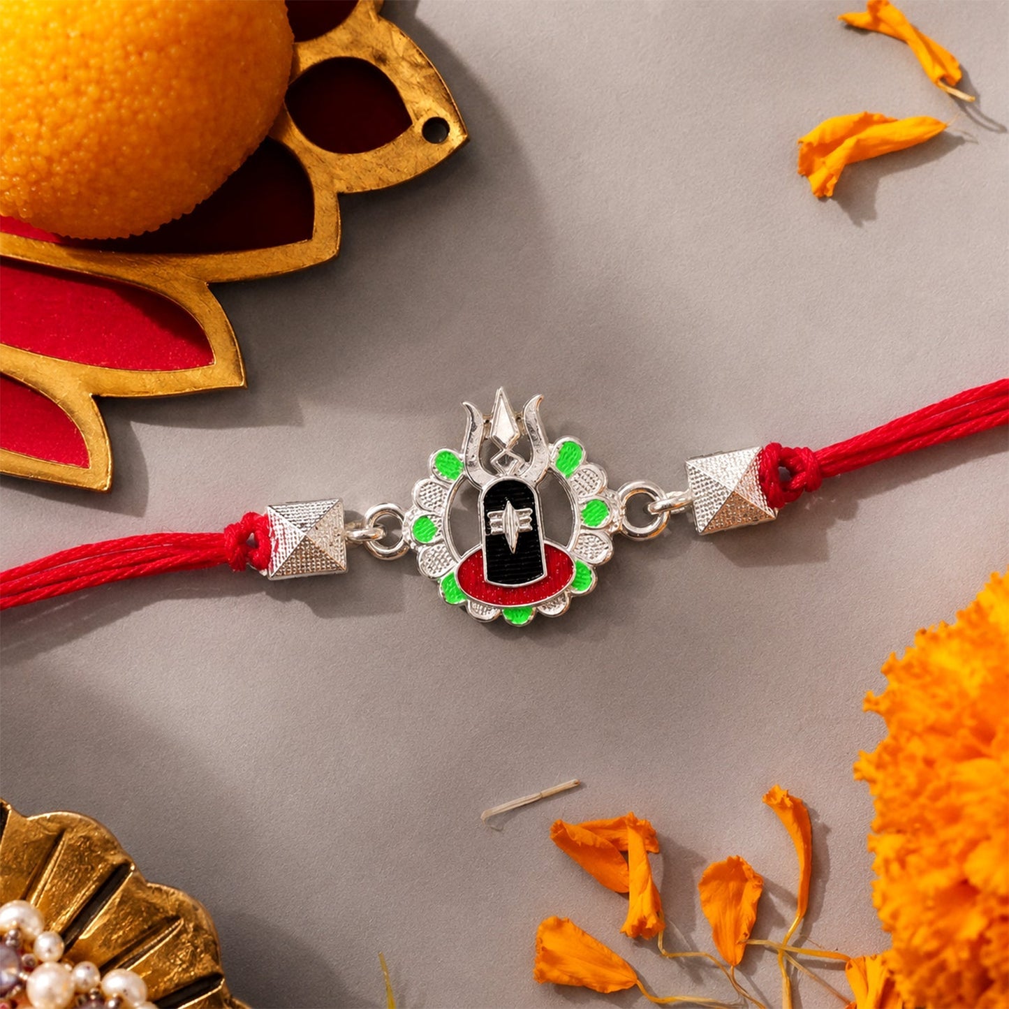 Beautiful Silver Shiv Lingam Trishul Rakhi with enamel beads, perfect for Raksha Bandhan celebrations