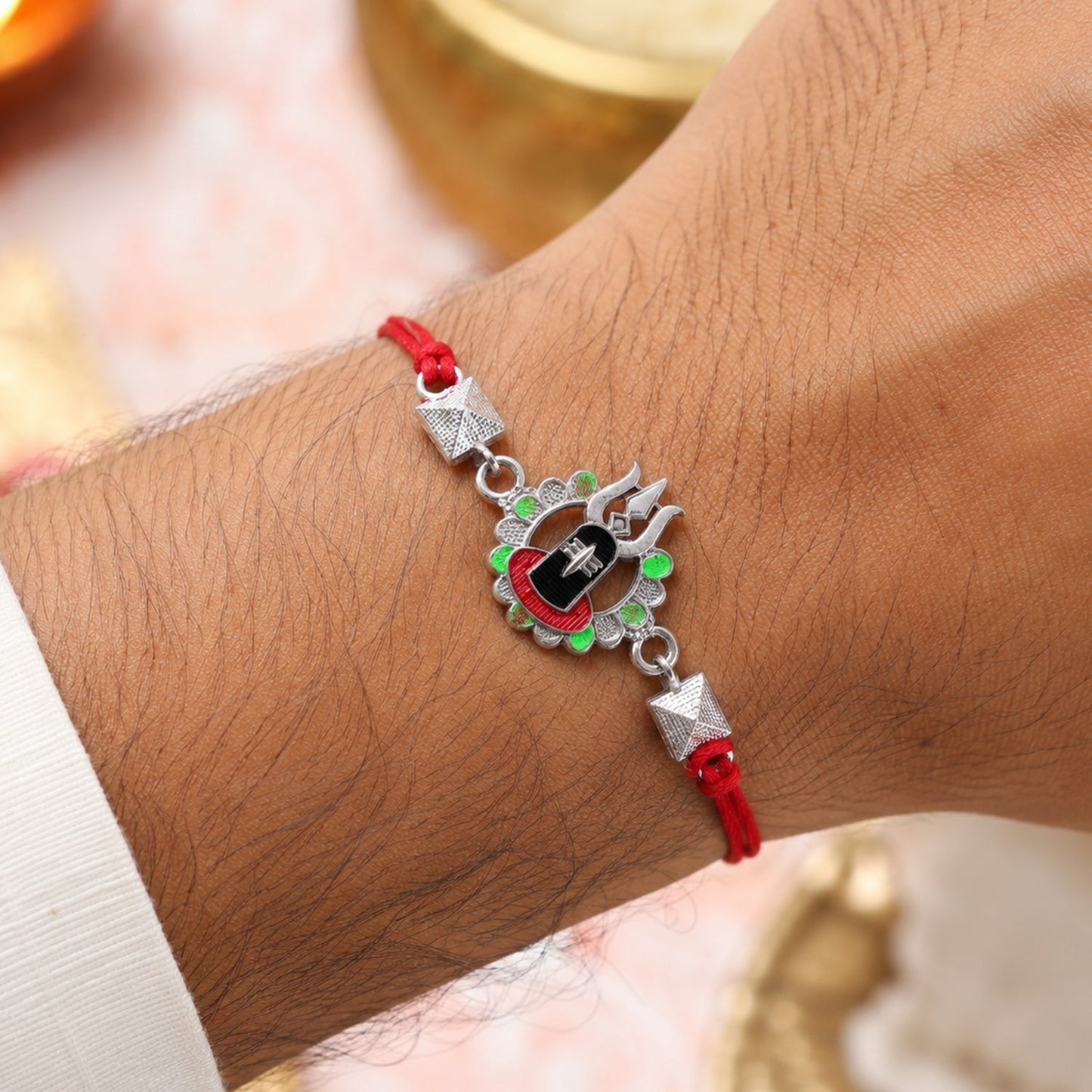 Close-up of Silver Shiv Lingam Trishul Rakhi showing intricate design and vibrant enamel beads
