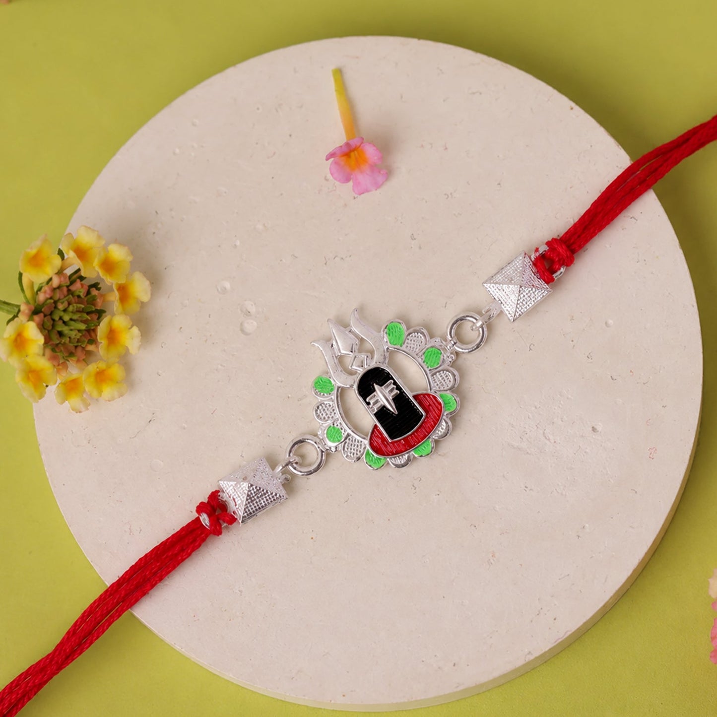Elegant Silver Shiv Lingam Trishul Rakhi displayed on a festive background