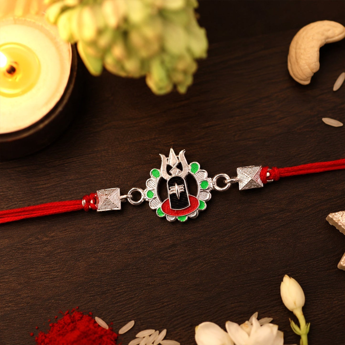 Premium traditional Rakhi featuring Shiv Lingam and Trishul motifs on a gift box