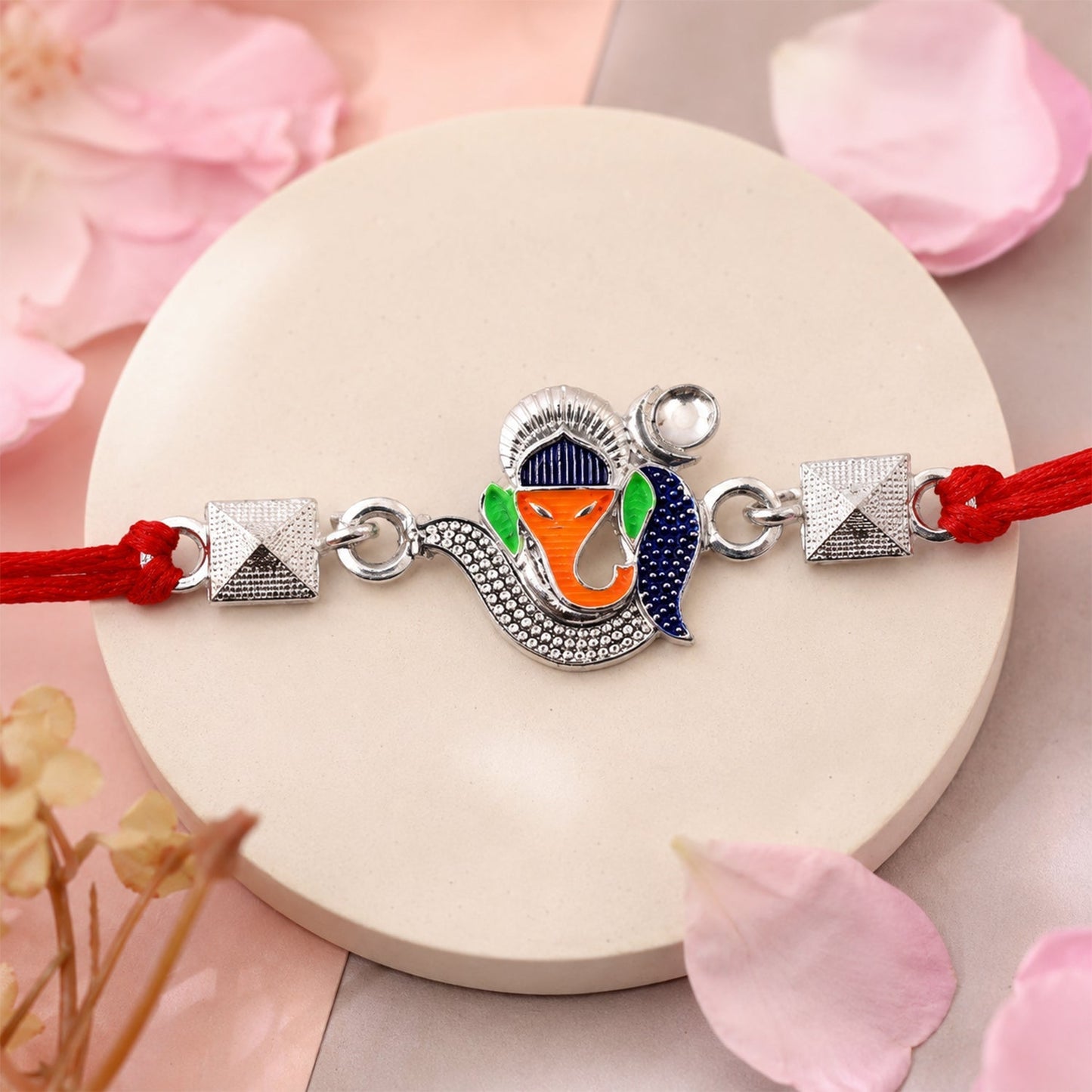 Traditional Rakhi featuring Silver Ganesha charm with colorful enamel