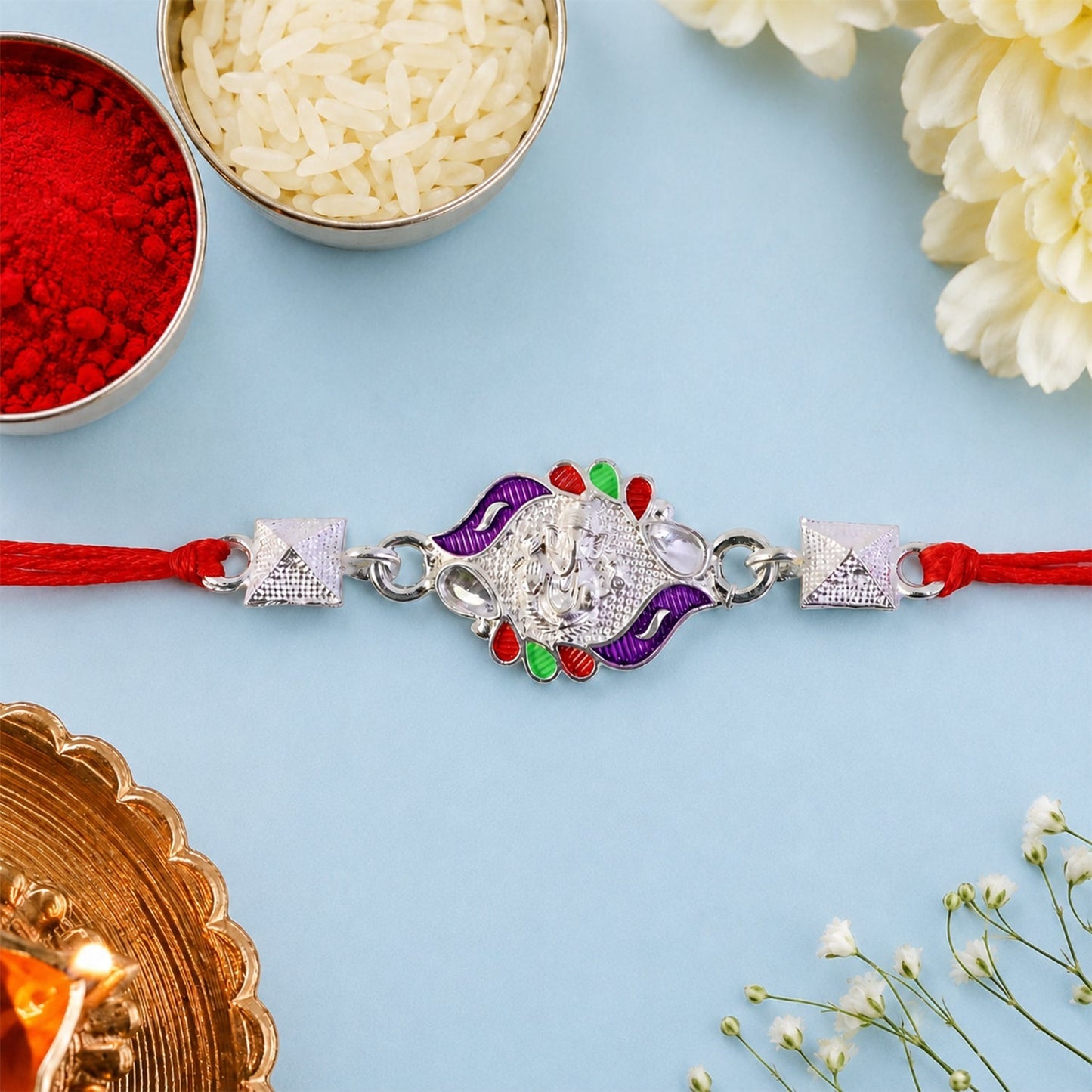 Silver Ganesha Rakhi with multicolor enamel beads and pyramidal design