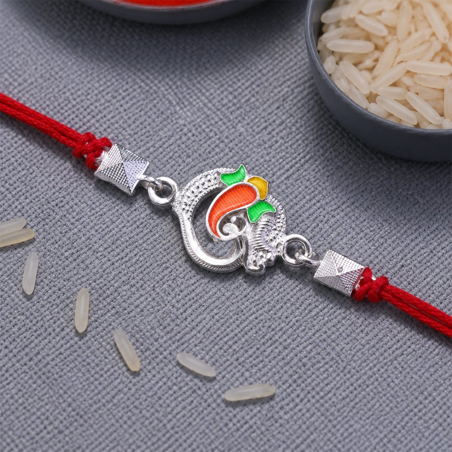 Stylish Silver Om Ganesha Rakhi with colorful enamel and premium look