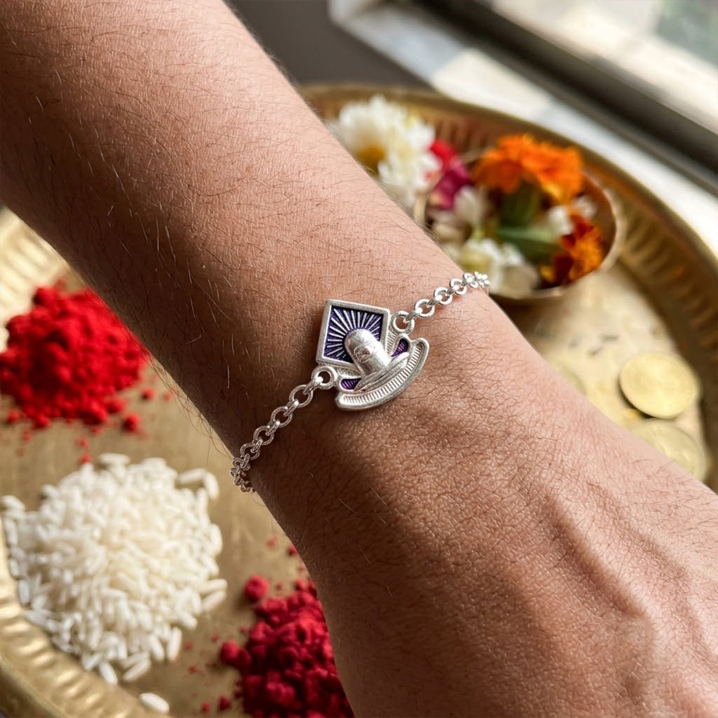 Elegant Shiv Lingam Rakhi with intricate enamel detailing for brother