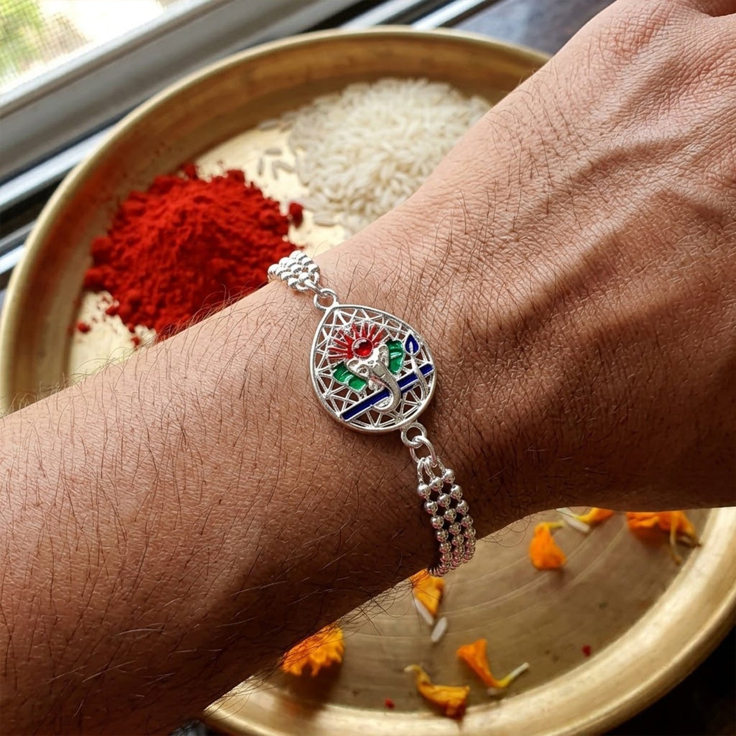 Traditional Lord Ganesha enamel charm chain bracelet rakhi with intricate design