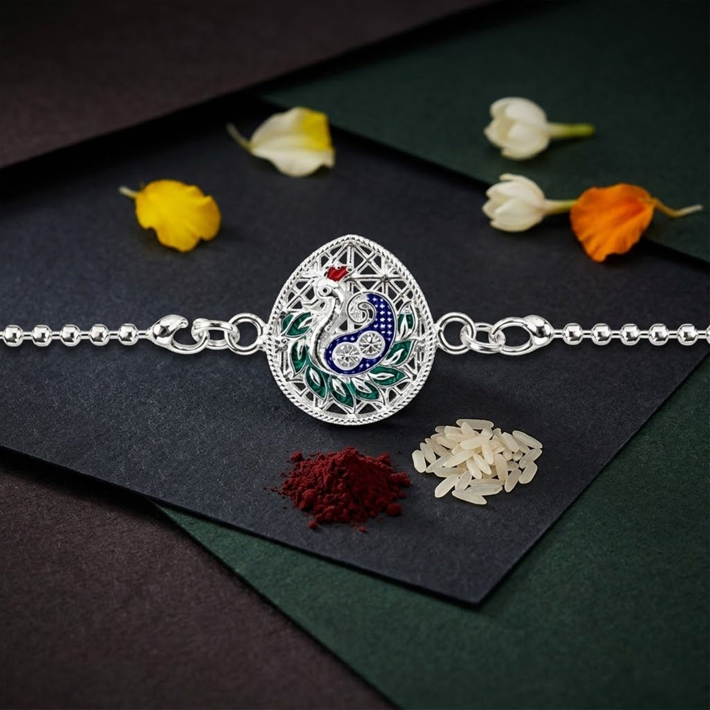 Peacock teardrop enamel charm chain bracelet Rakhi displayed as a festive accessory