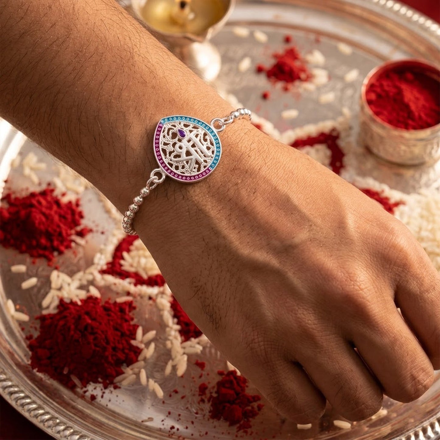 Elegant enamel teardrop charm with intricate design for Raksha Bandhan